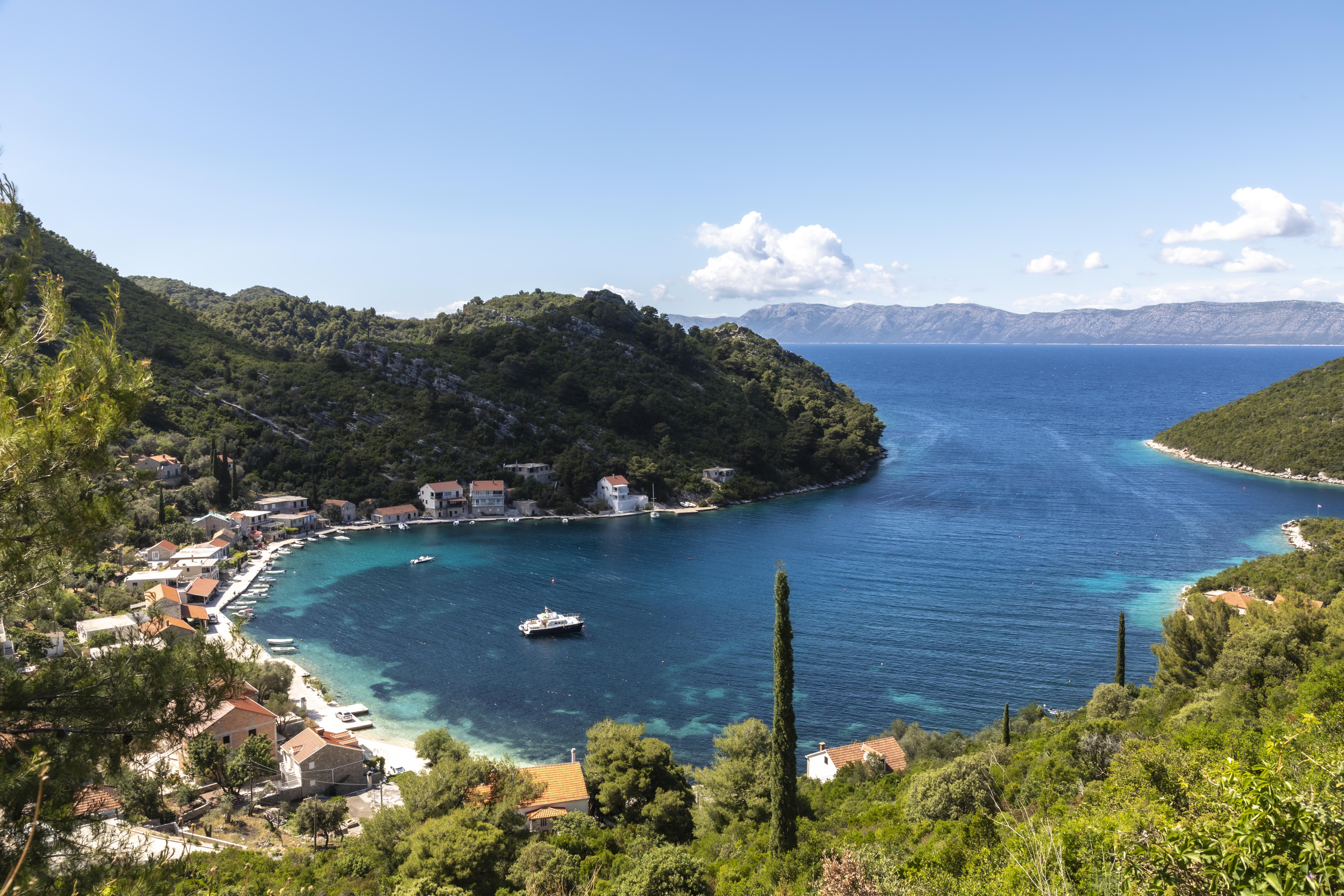 Rural village nestled on bay surrounded by blue waters