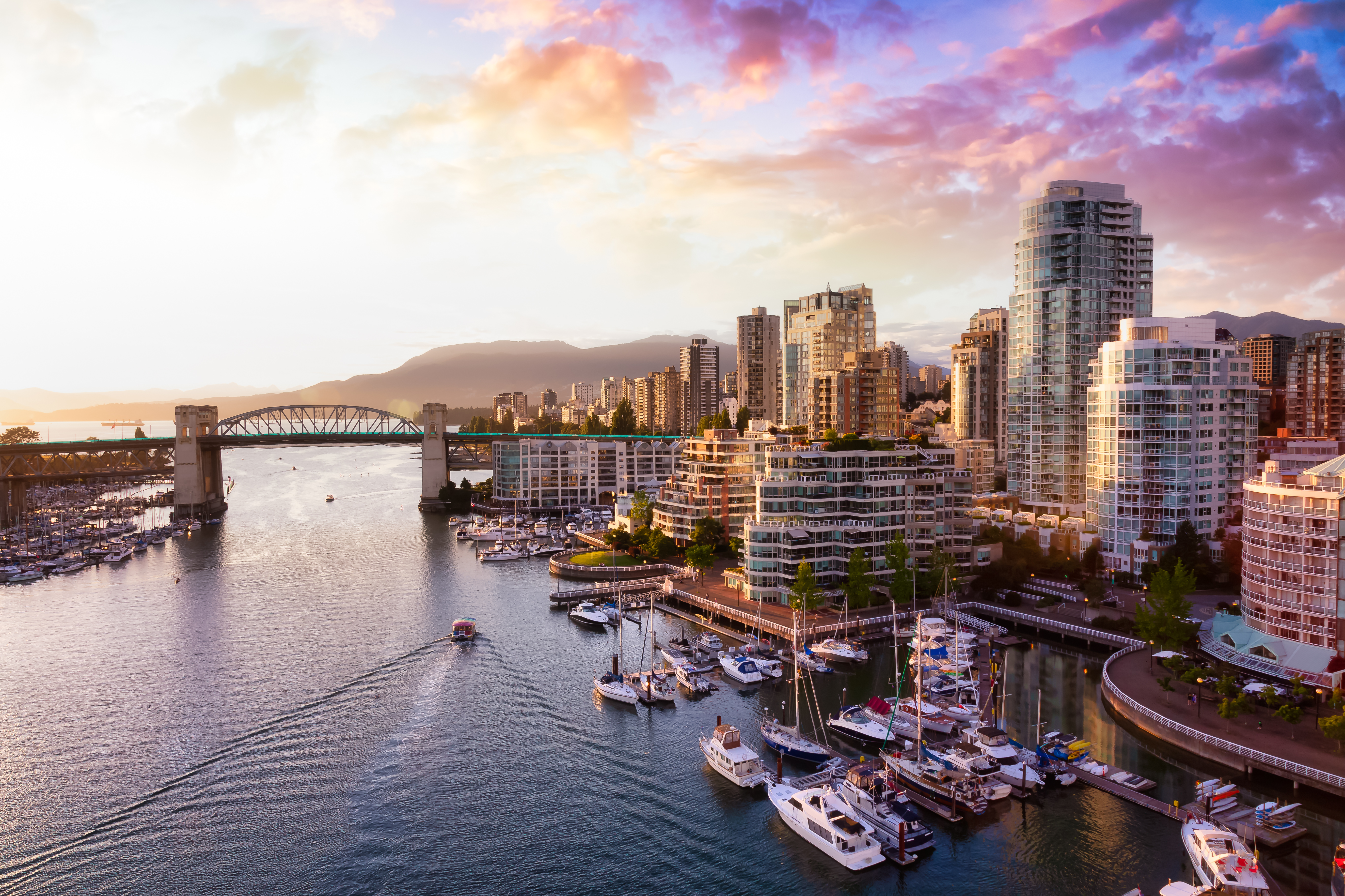 iew of Burrard Bridge and False Creek in downtown, taken during a beautiful cloudy sunset.
