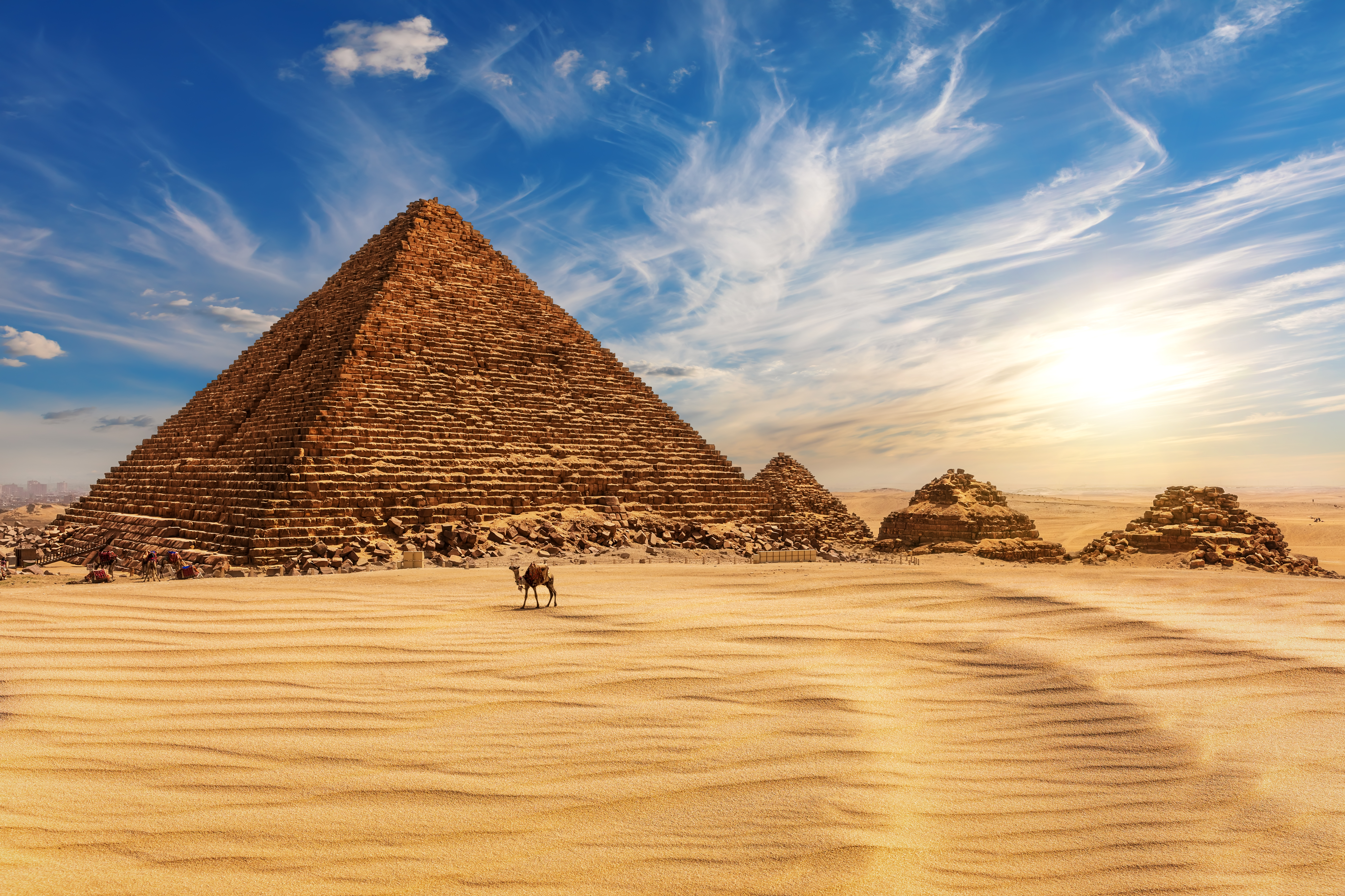 The Pyramid of Menkaure at sunset in Egypt and a camel nearby