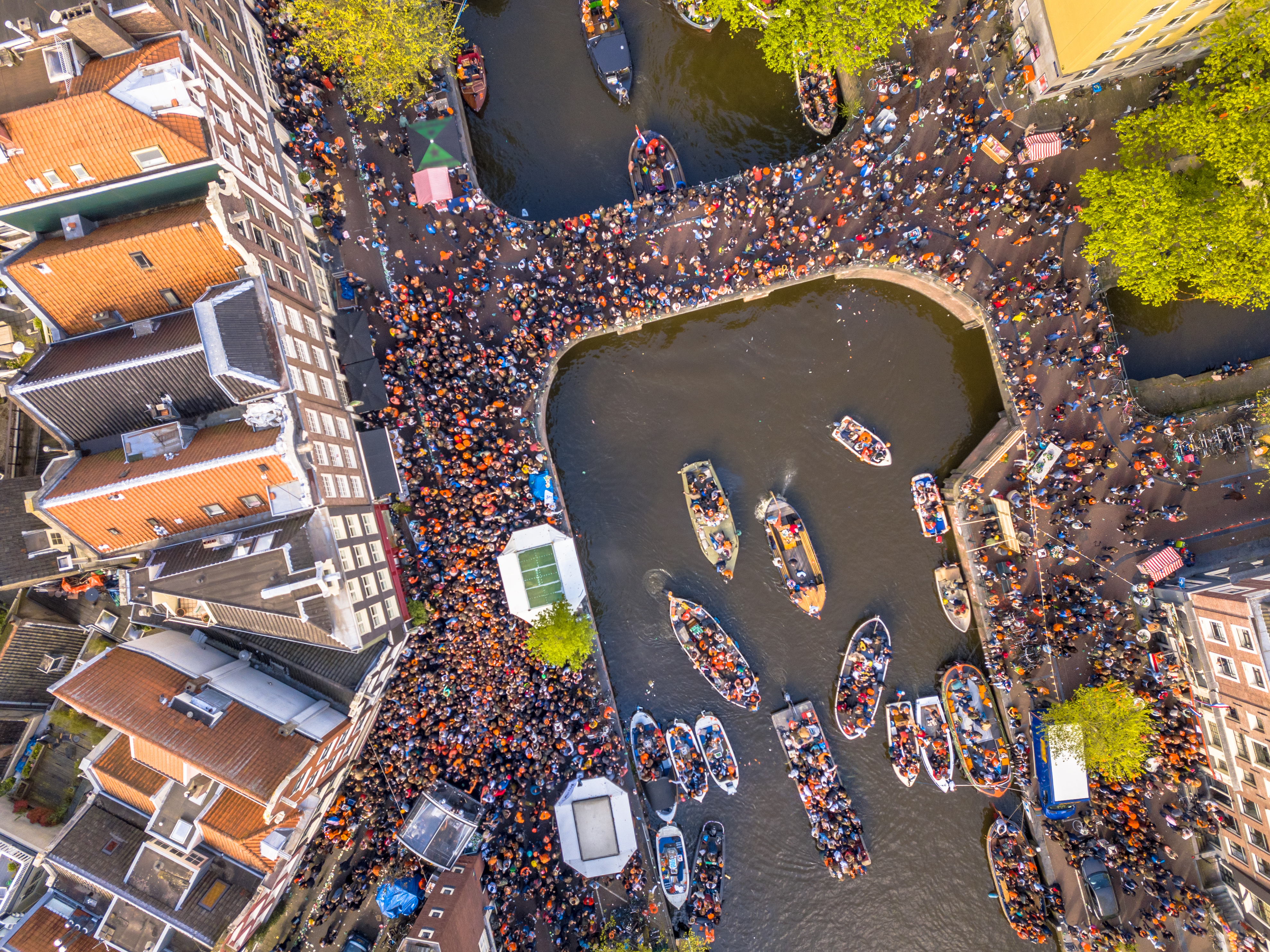 Canal boat parade on Koningsdag Kings day festivities in Amsterdam. Birthday of the king
