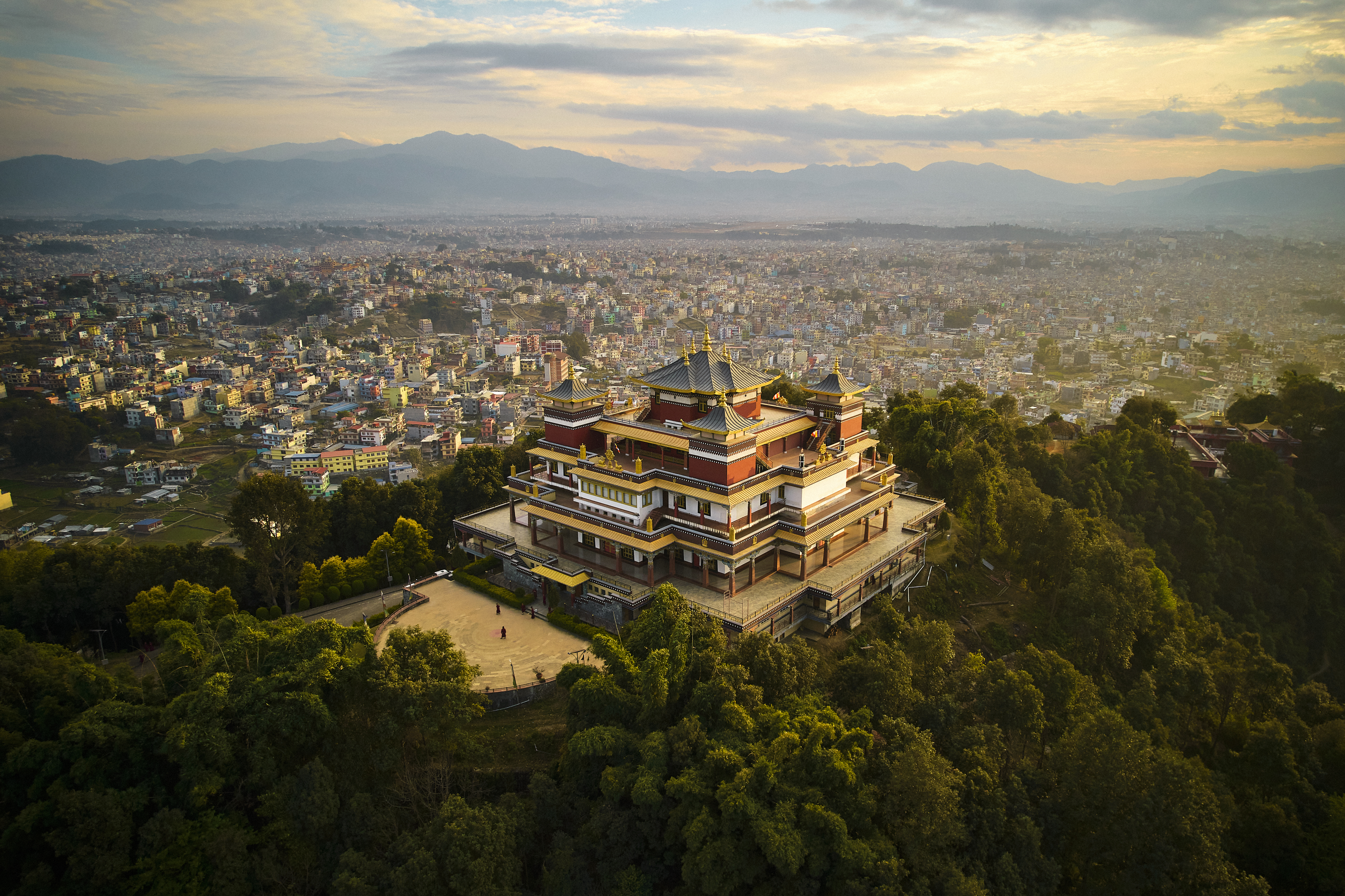 "Pullahari Monastery, Buddhist pilgrimage site on northern hill in Kathmandu Valley with city and mountains in background. "
