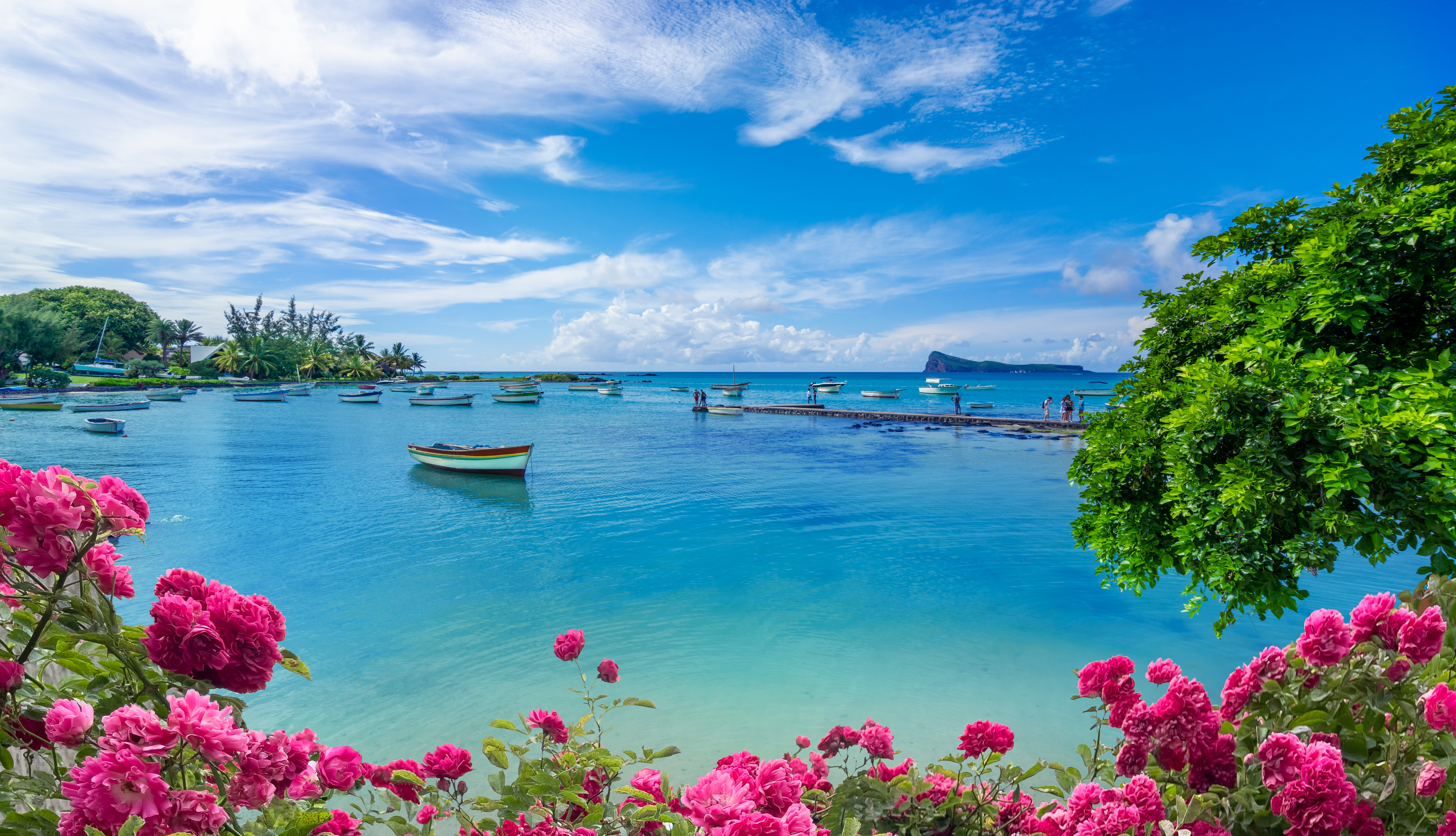 "Landscape view of the blue transparent sea, boats and beach in the summertime in Mauritius "
