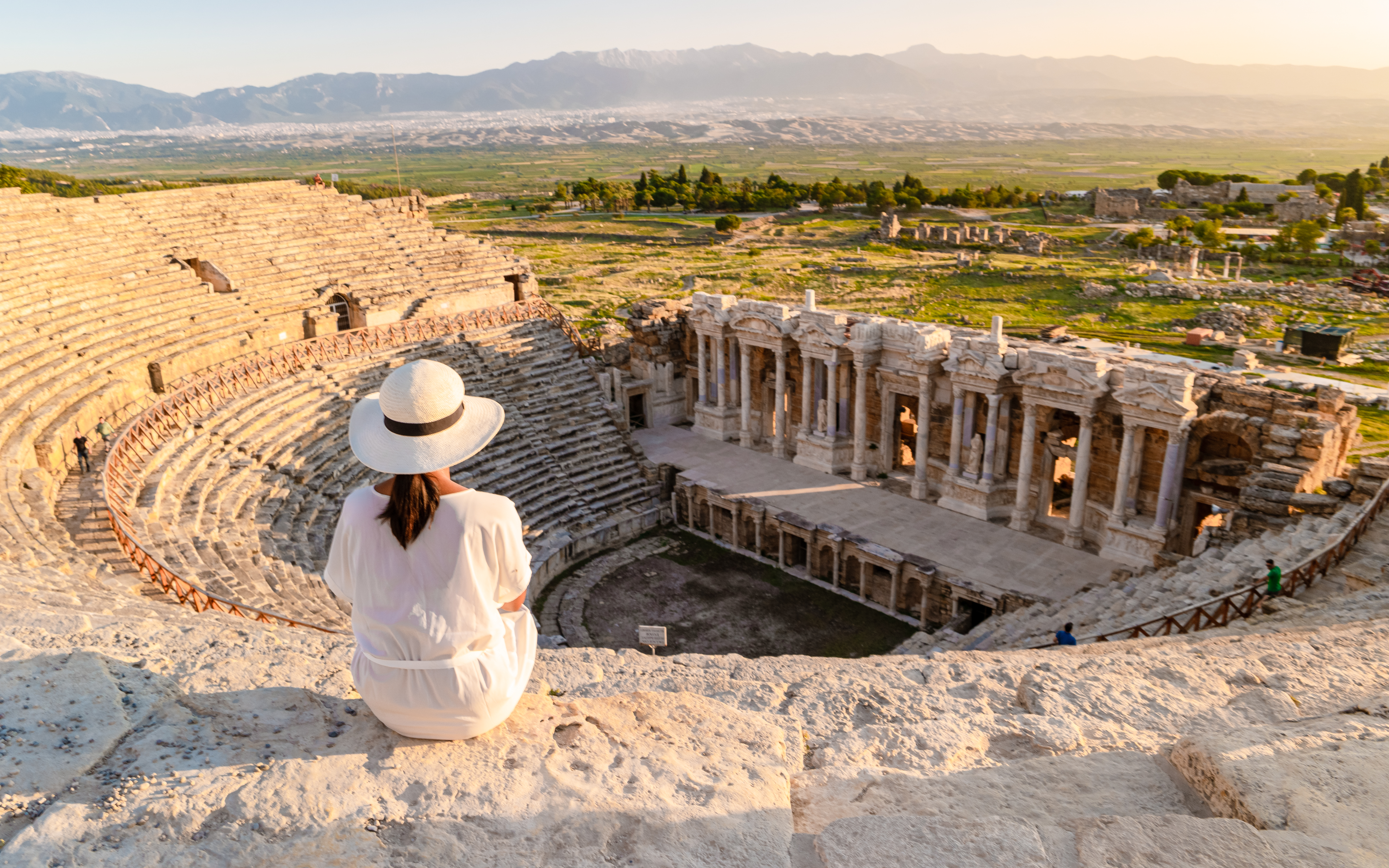 Hierapolis ancient city Pamukkale Turkiye, a young watching the sunset by the ruins Unesco site