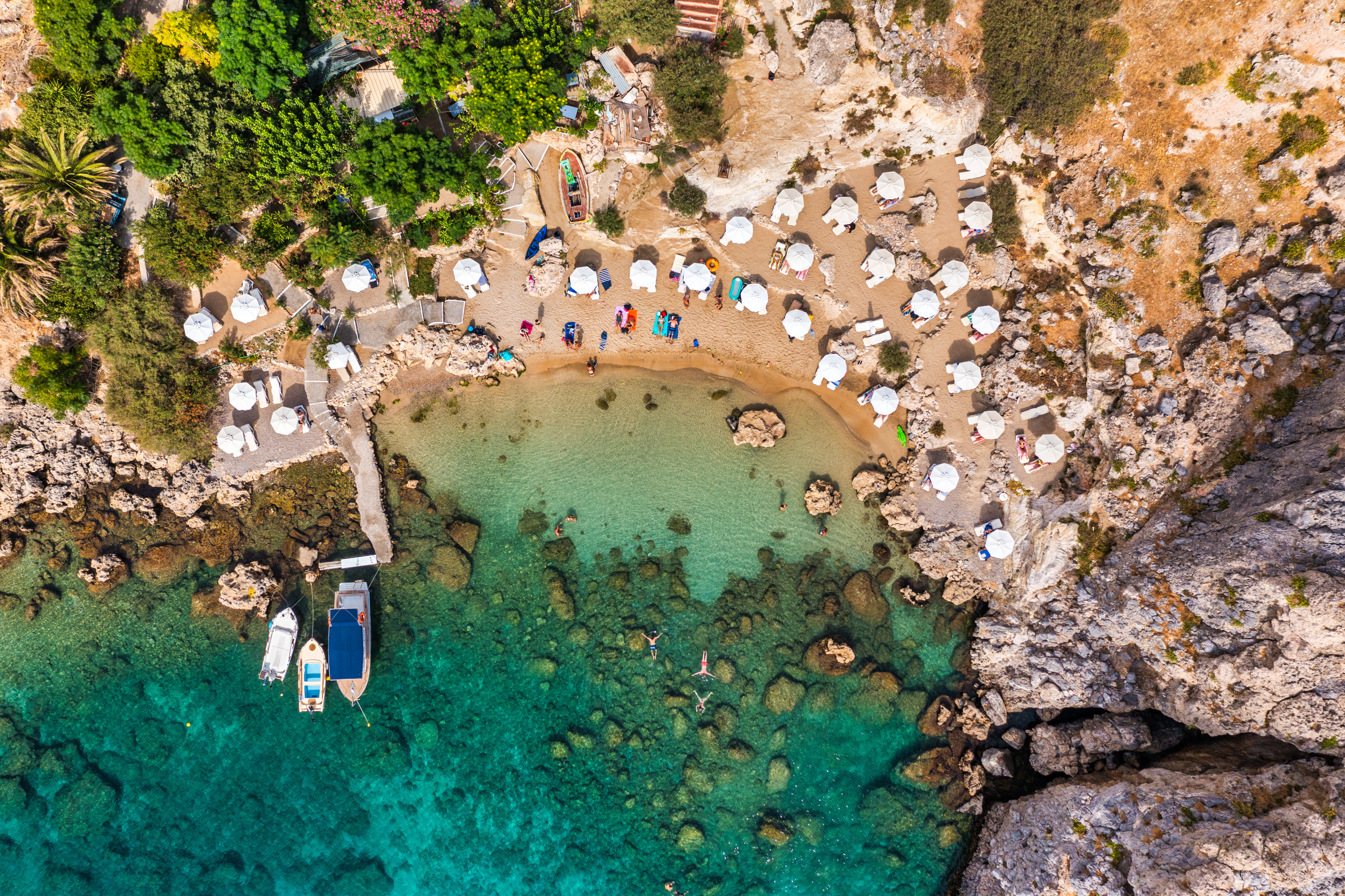 Aerial photo of beach goes and boats in the bay