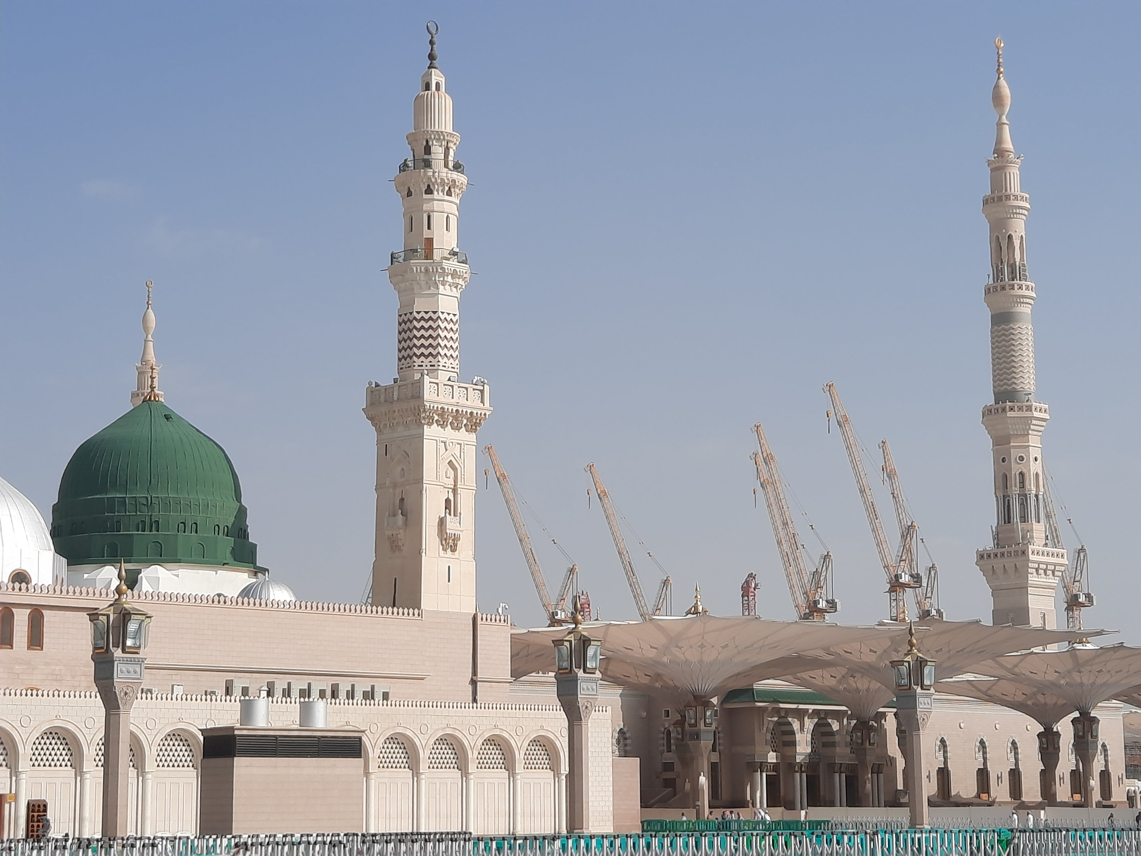 Beautiful daytime view of Masjid Al Nabawi, Medina's green dome, minarets and mosque courtyard