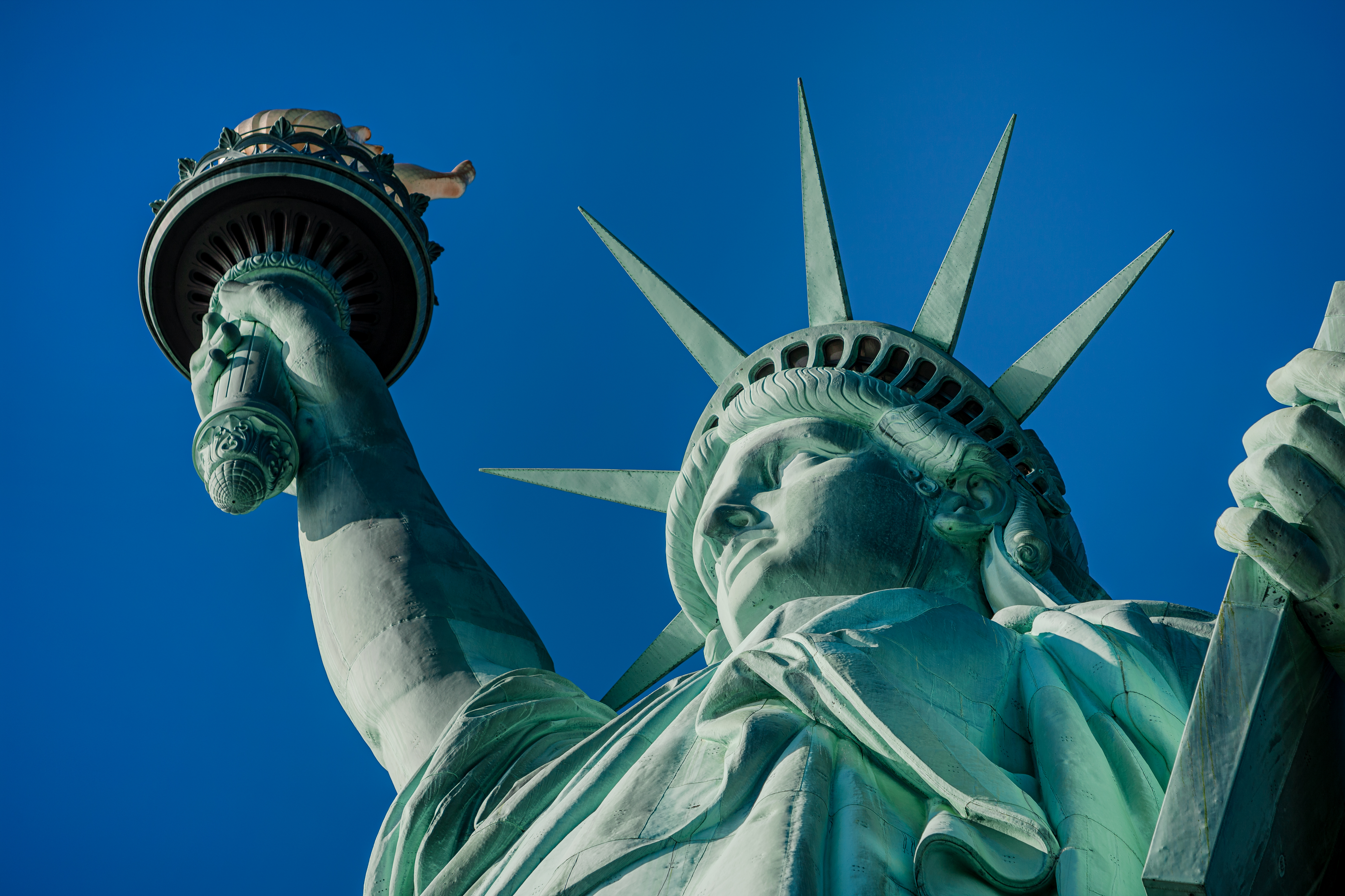 Statue of Liberty in a blue summer sky. Landmark of New York Blue sky