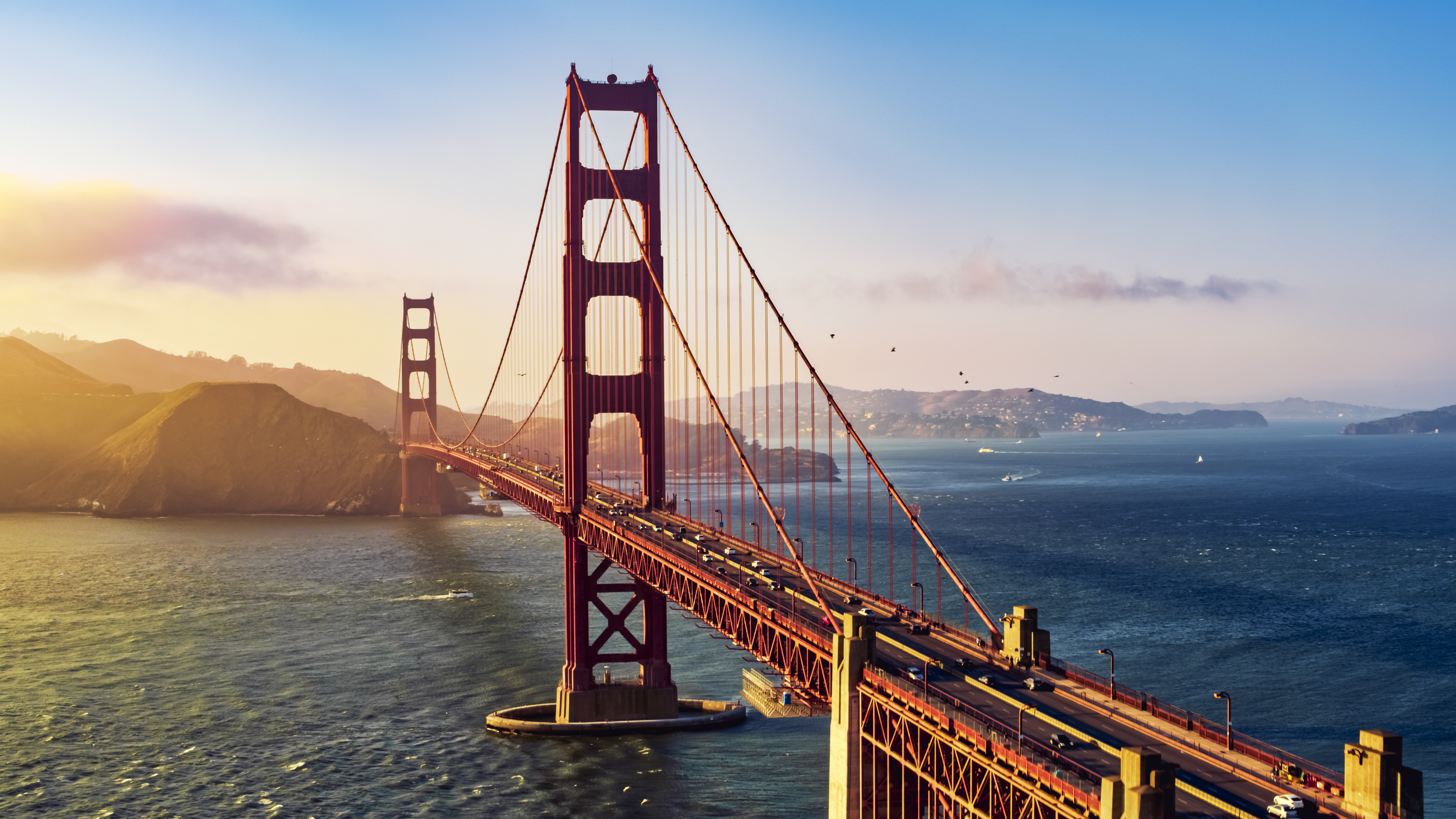 Aerial view of traffic moving on Golden Gate Bridge during sunset