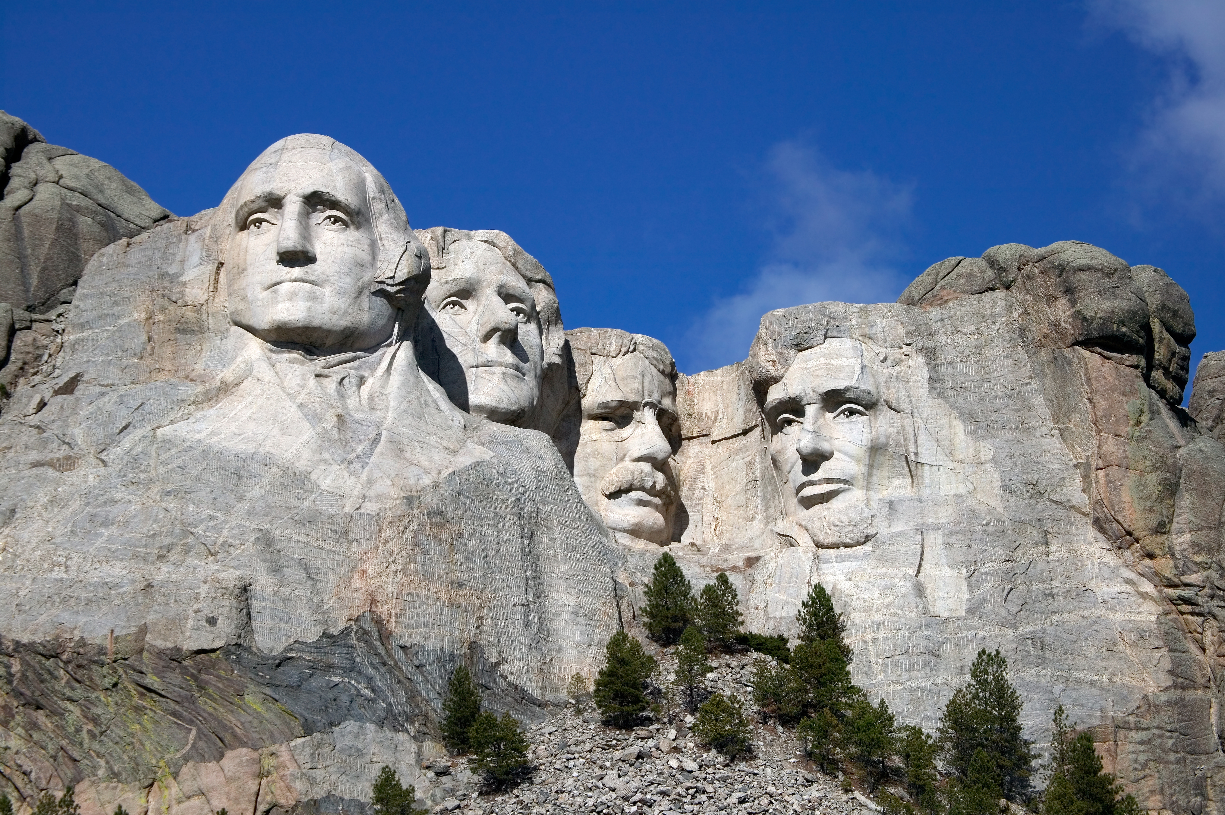 Close up view of Mount Rushmore under a blue sky
