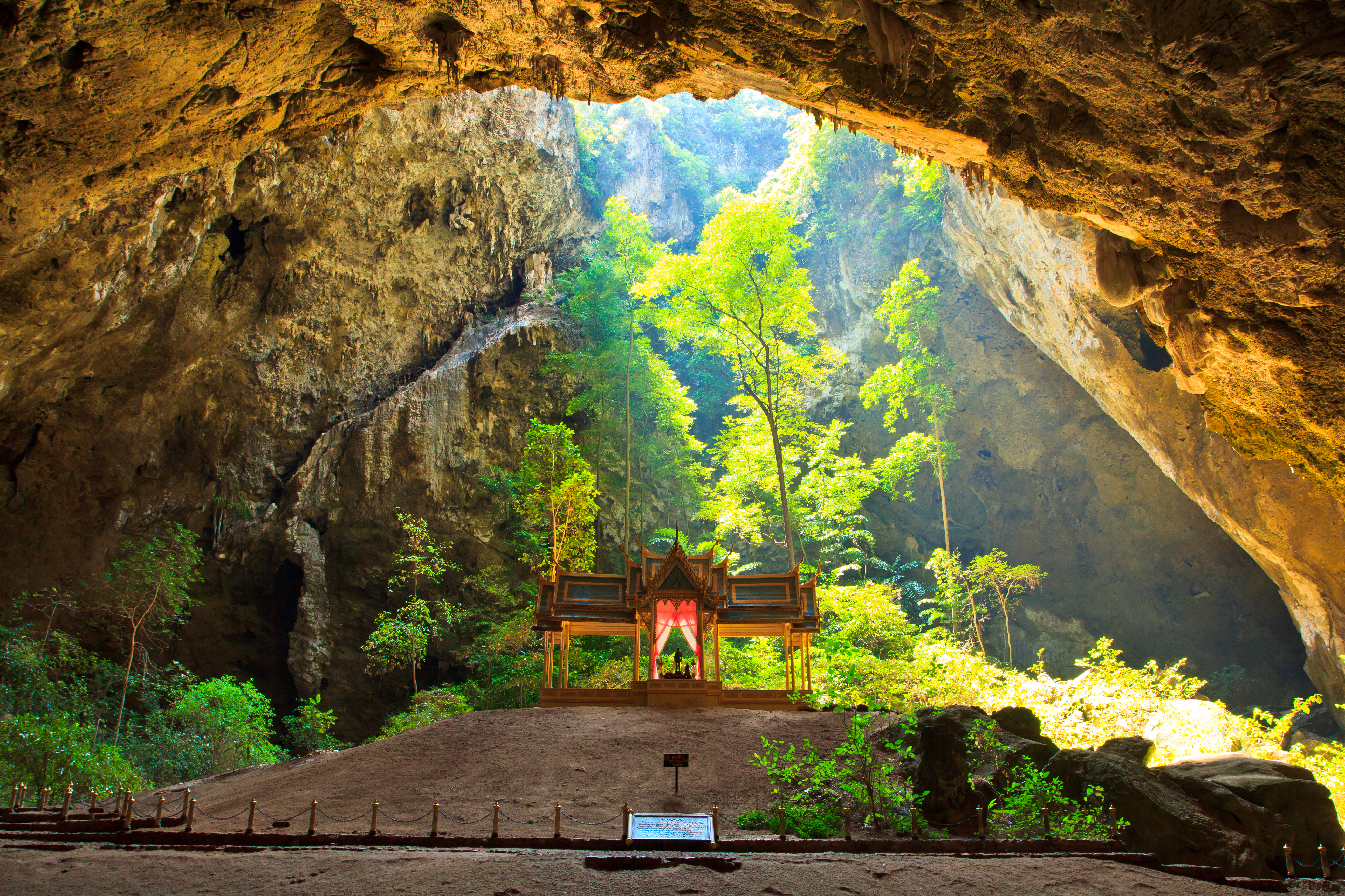 Sunlight shines down through Phraya Nakorn cave hole on pavillion of the king, Sam Roi Yot National Park