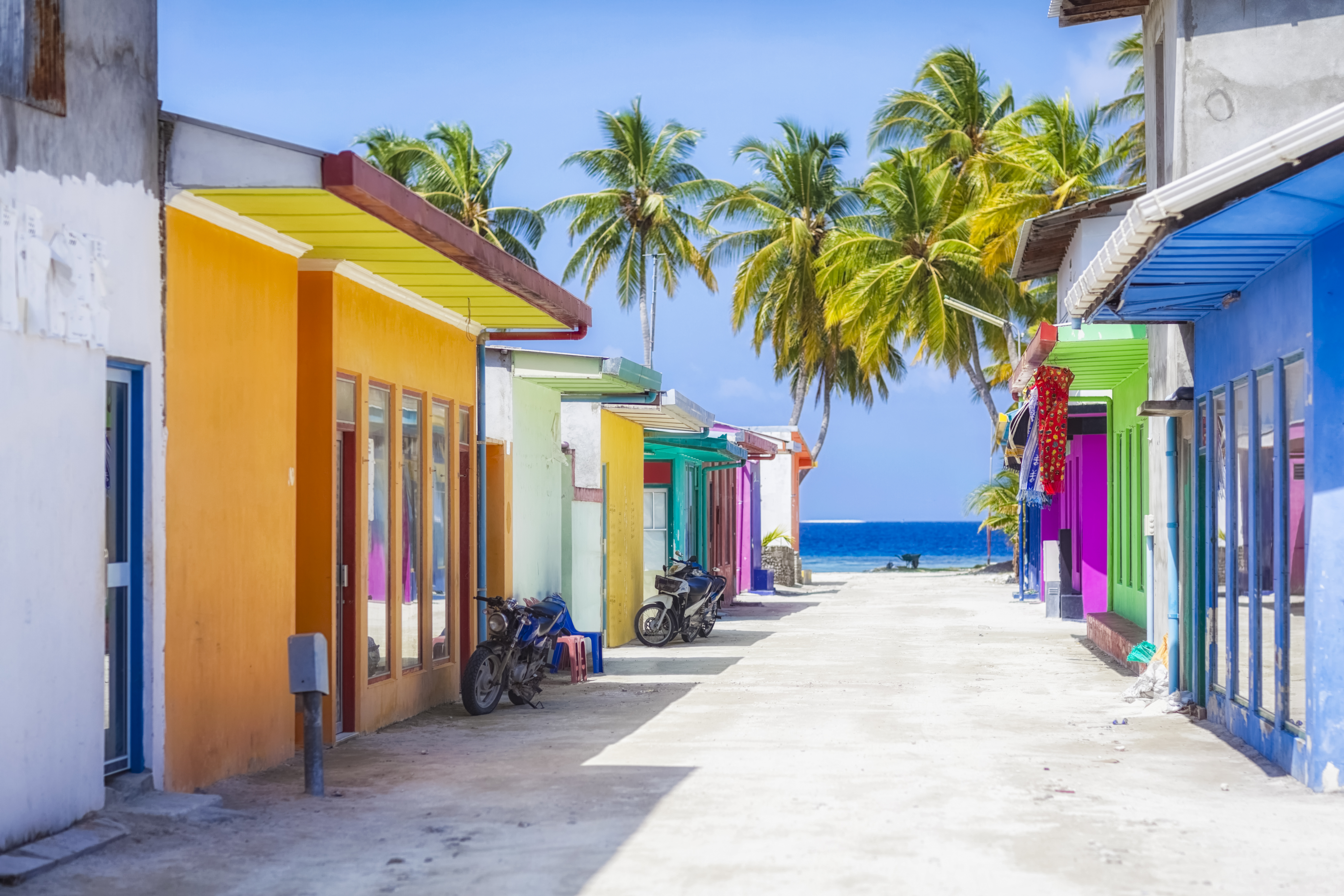 Shopping street with typically colorful house facades in Maafushi a local island in the Maldives.