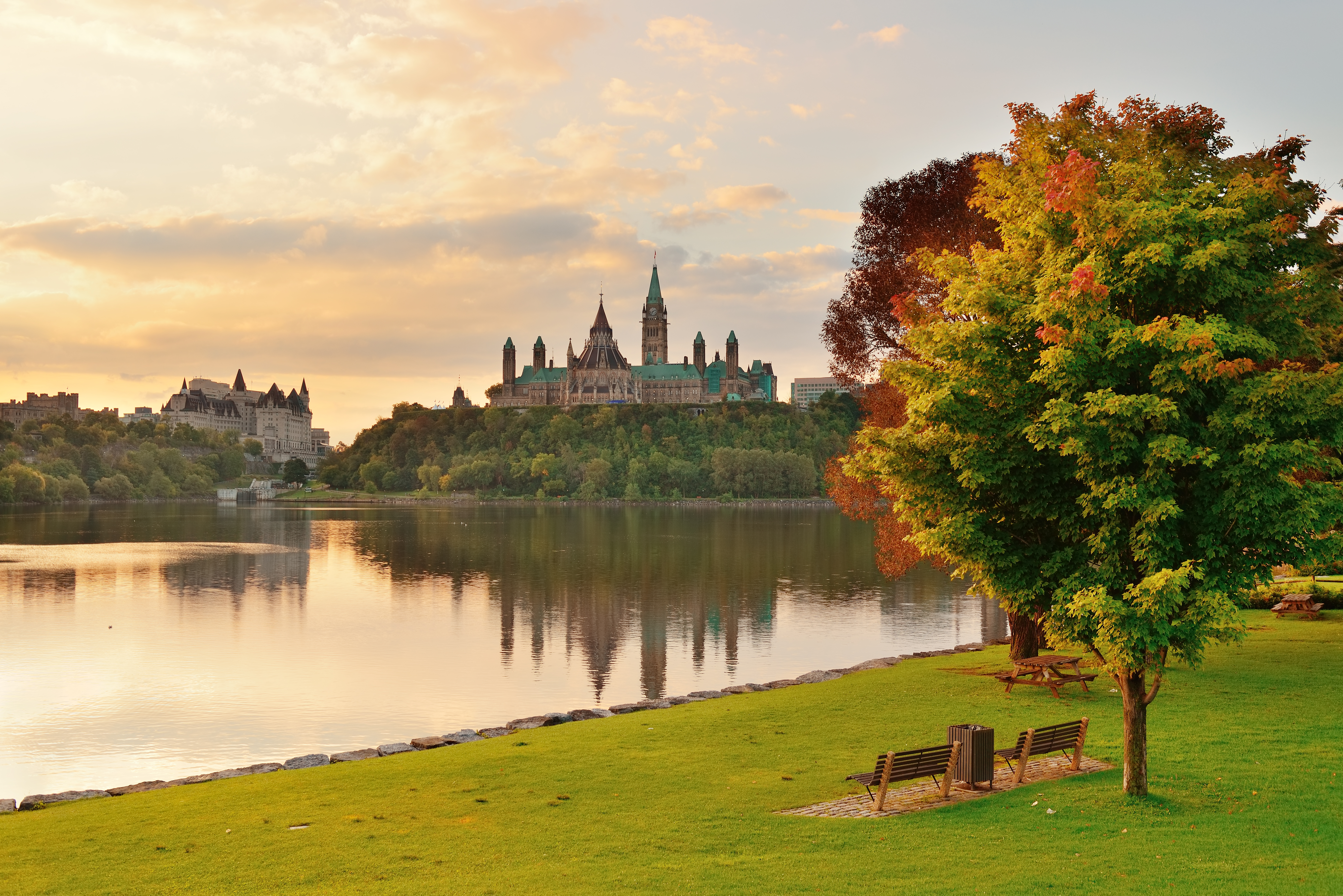 Ottawa city skyline with Parliament Hill at sunrise in the morning park view over river