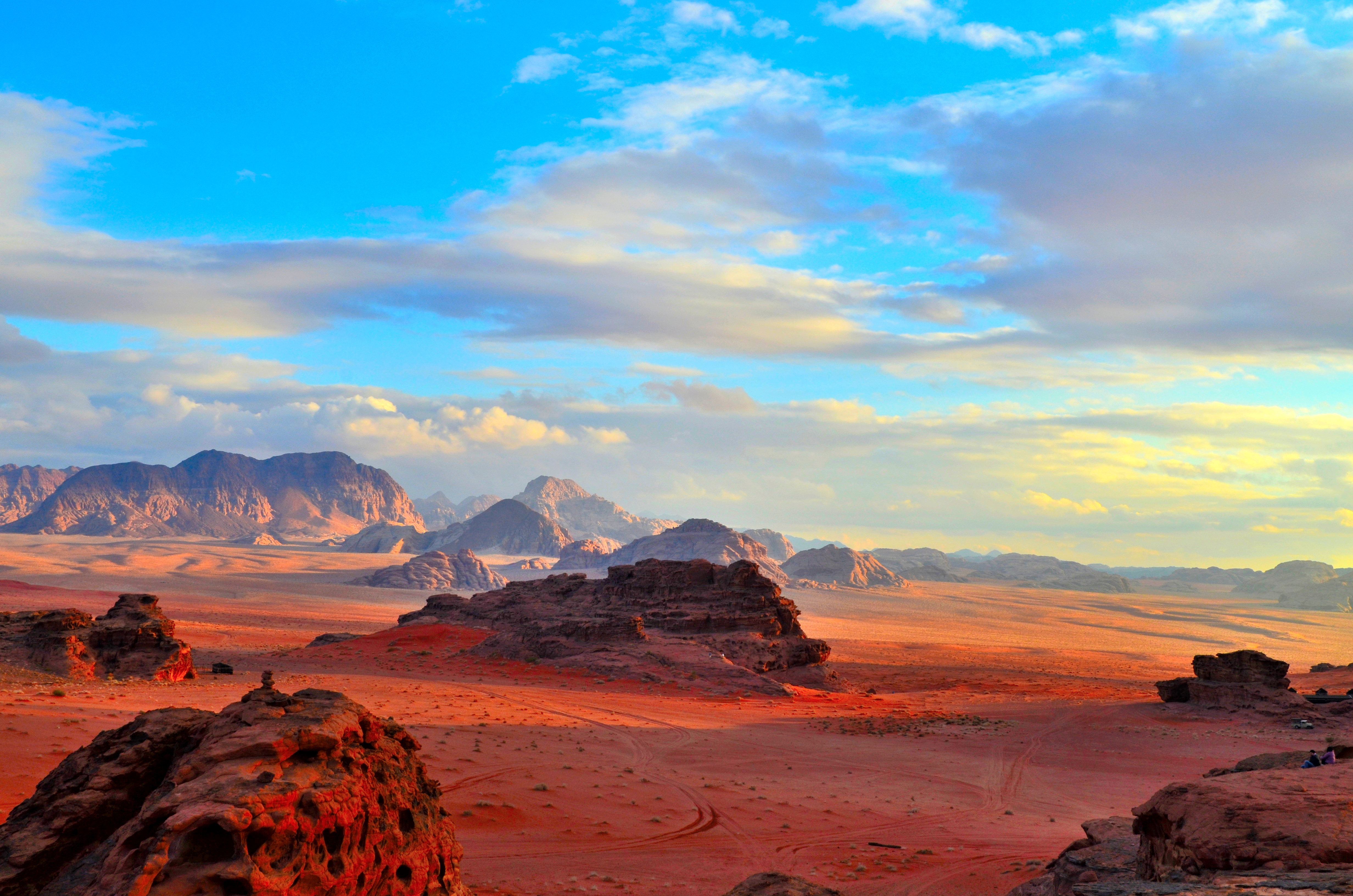 Sunset over rock formations and red desert