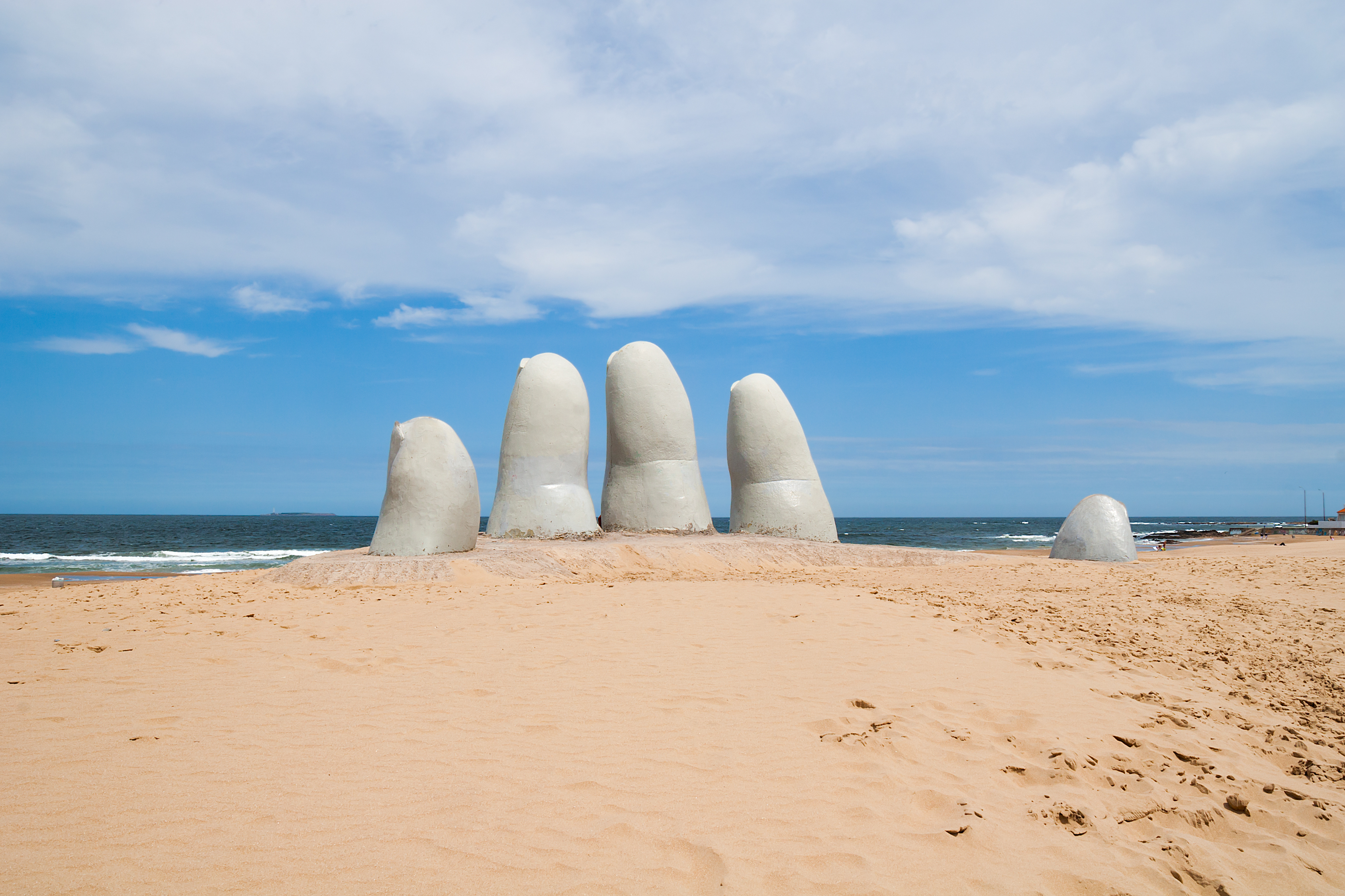 Oversized hand sculpture, comes out from the sand along coast, a symbol of Punta del Este, Uruguay