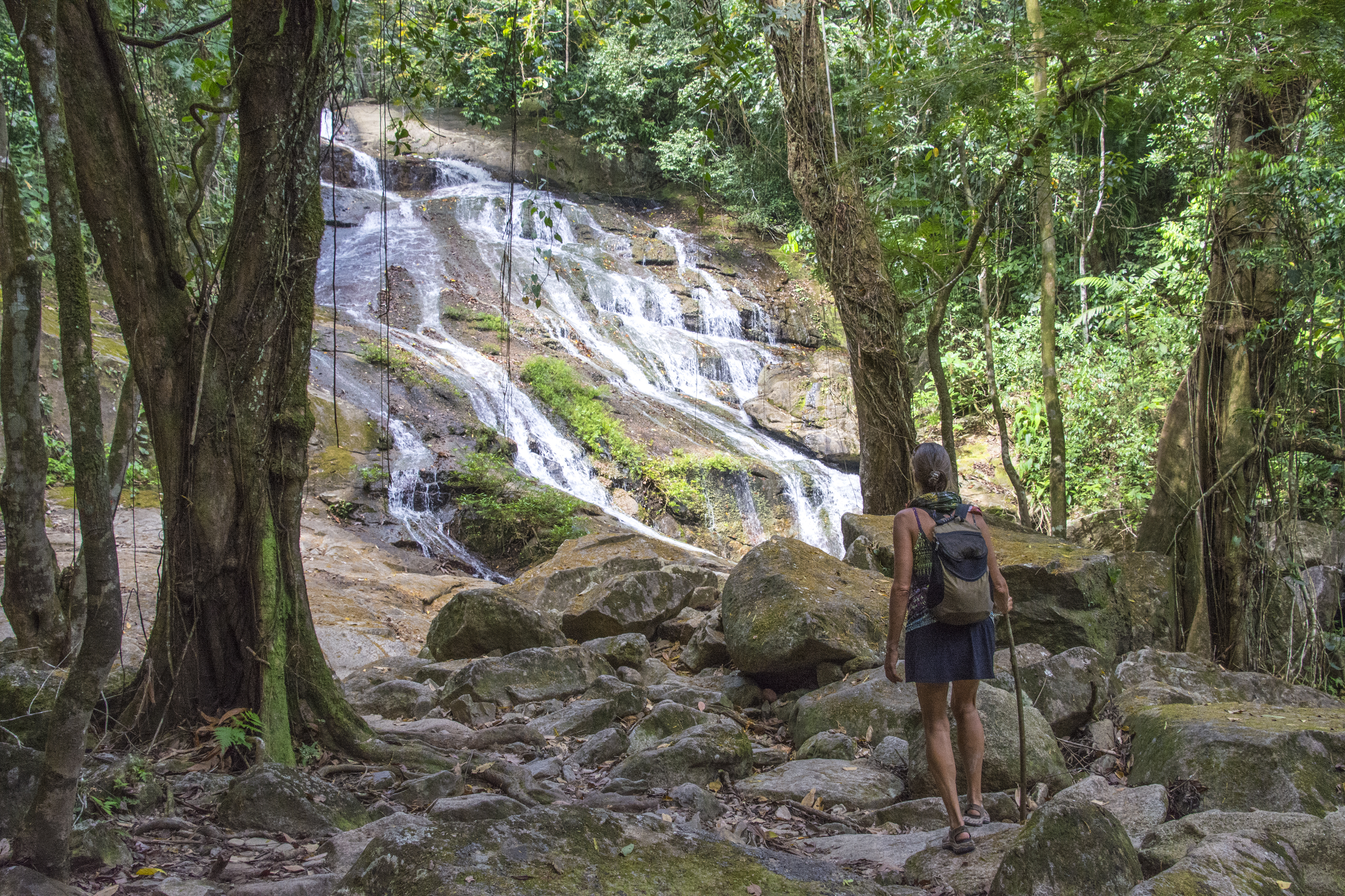 Woman approaching Bocawina Falls. Bocawina National Park, Belize.