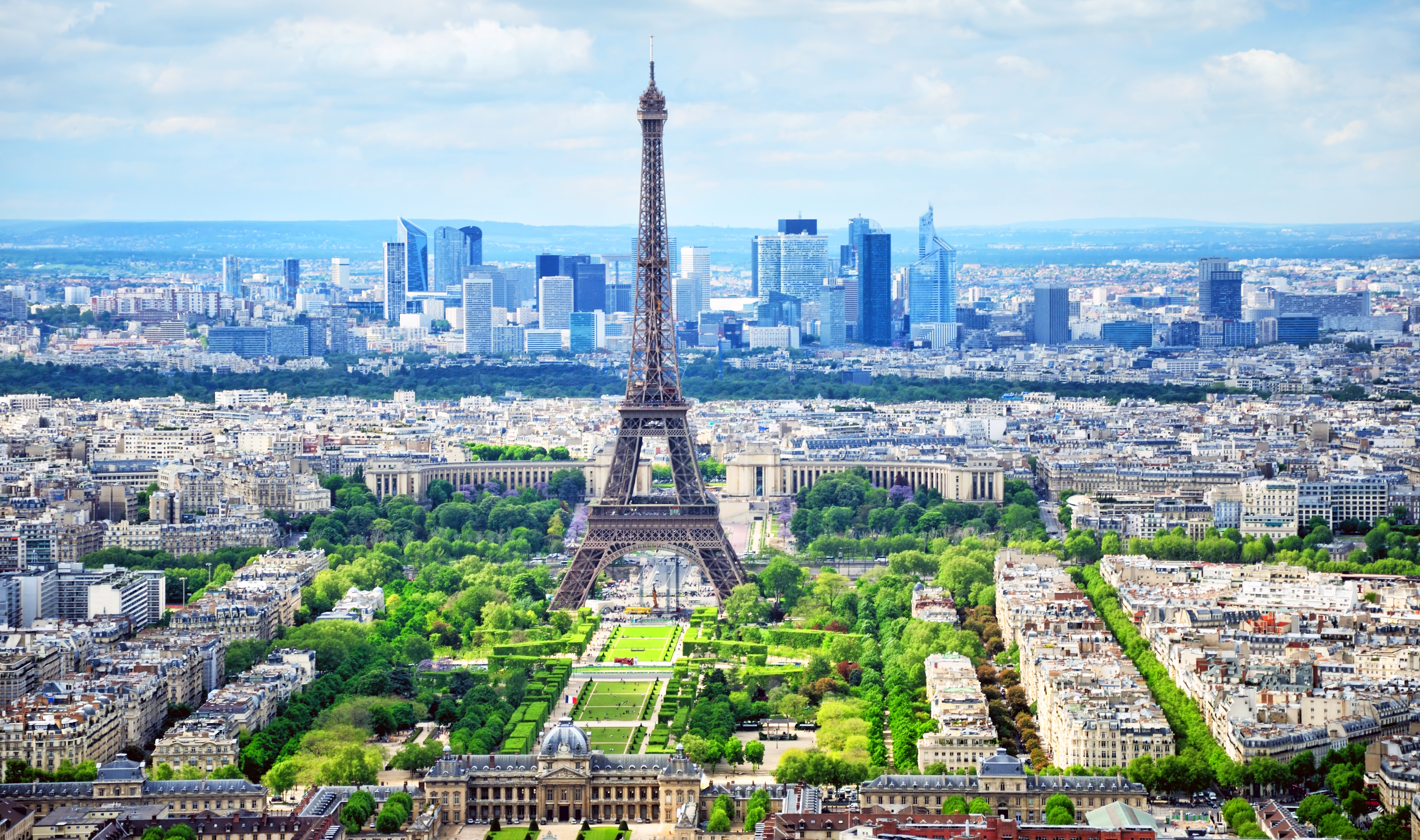 Aerial view of Paris with Champ-de-Mars, Eiffel Tower and skyscrapers of La Defense