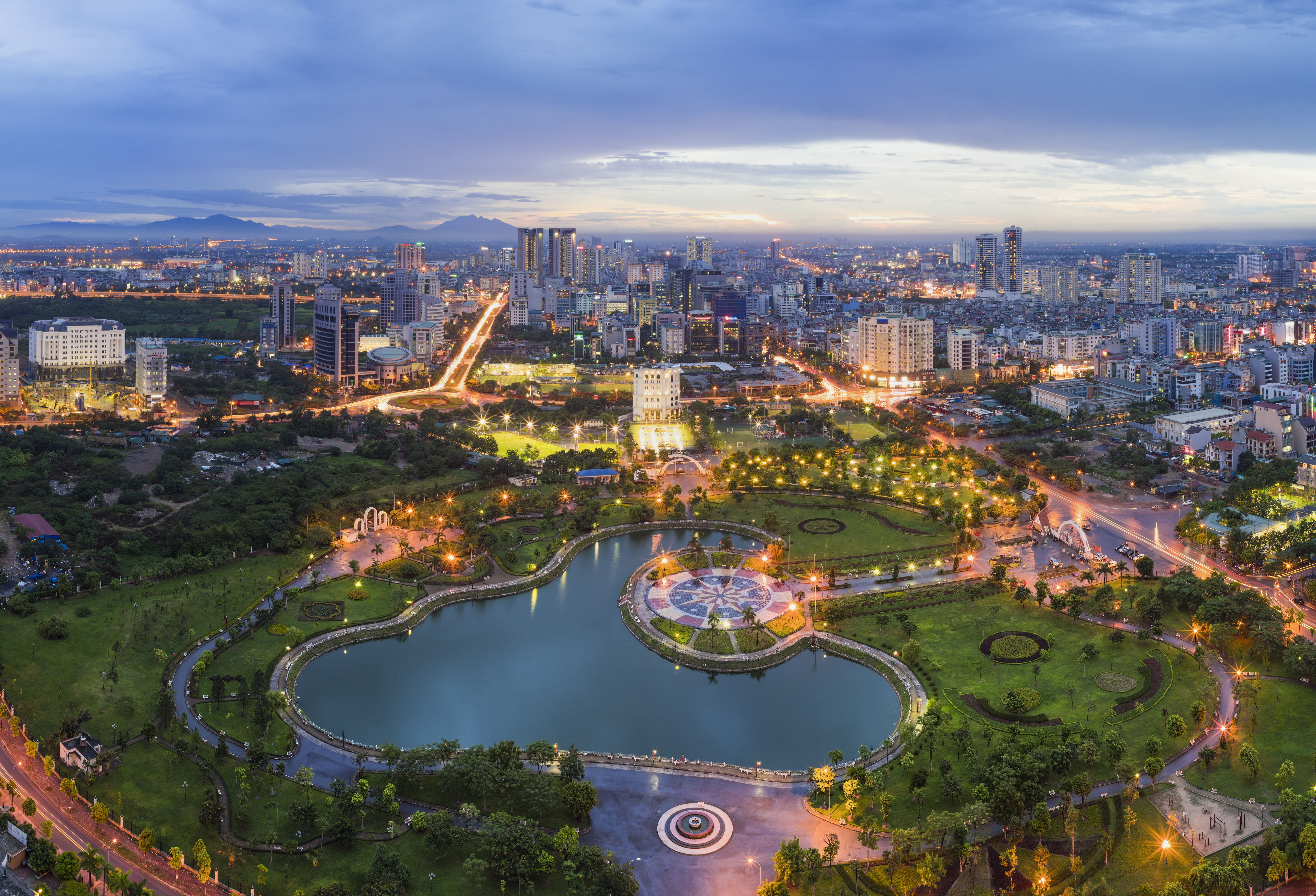 Hanoi skyline cityscape at twilight period, iwth Cau Giay park in foreground