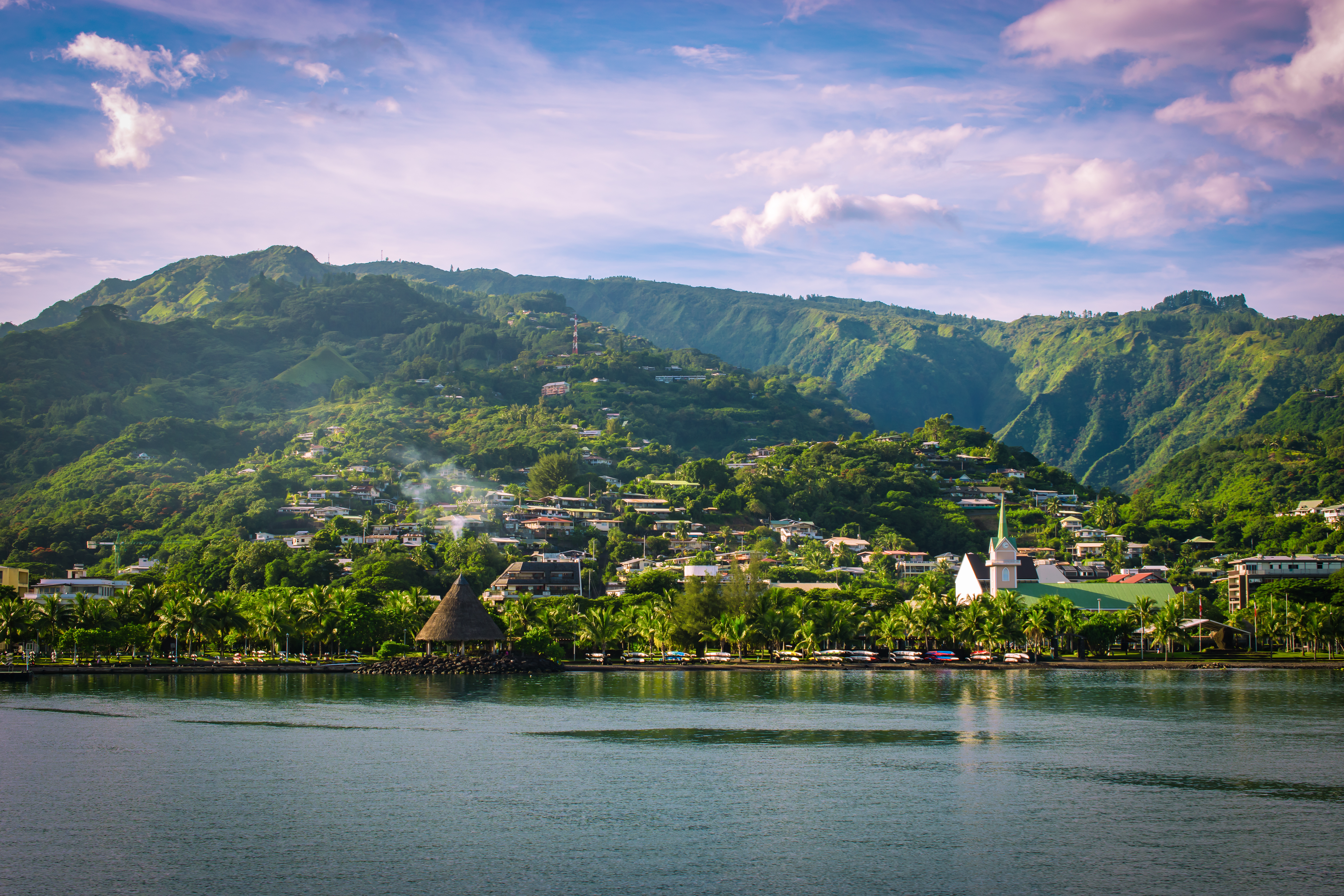 Landscape of Tahiti with mountains and village close to the port of Papeete, French Polynesia