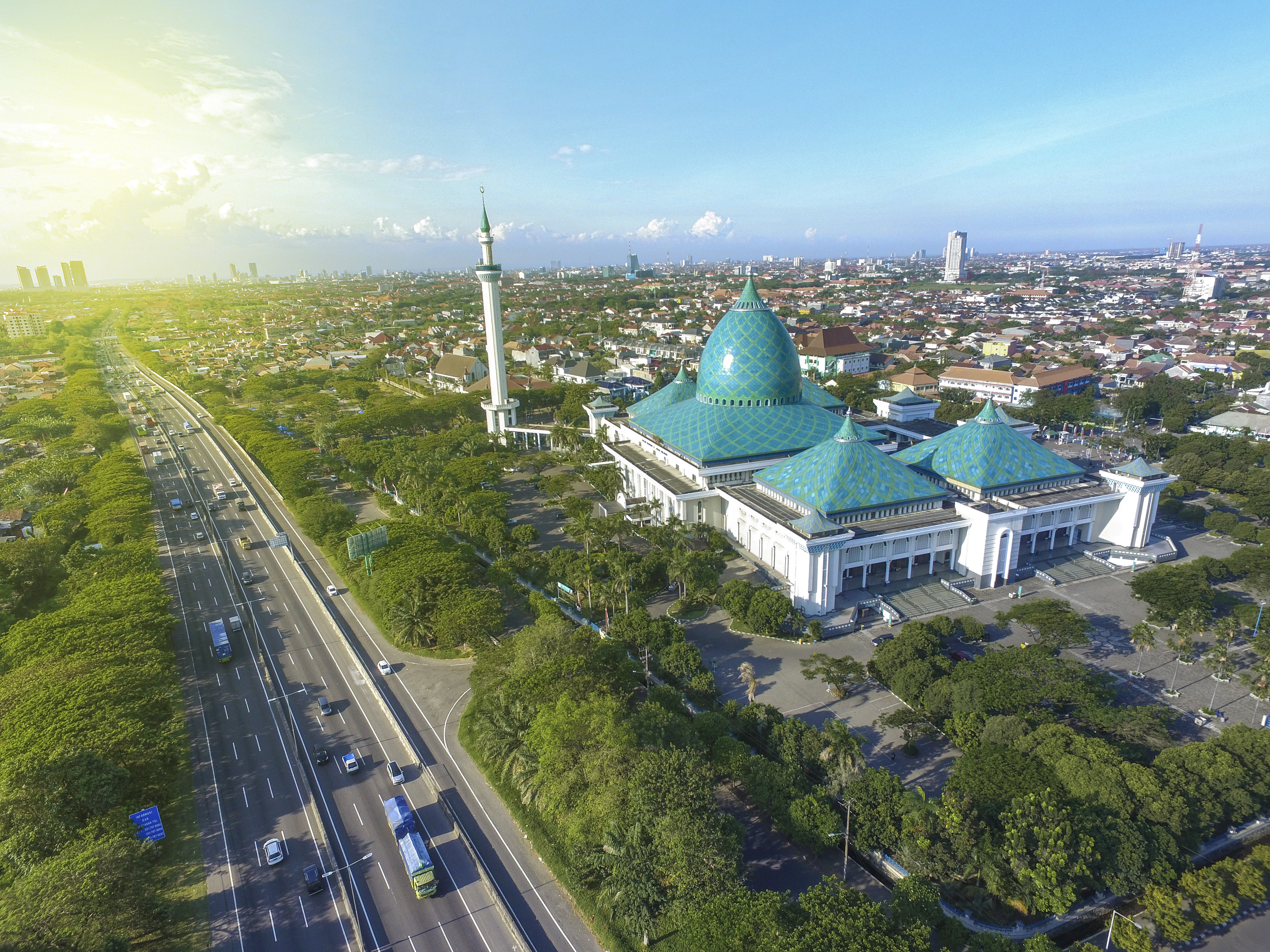 Skyline of Surabaya with Al Akbar Mosque in the foreground. Surabaya is a port city of on the Indonesian island of Java.