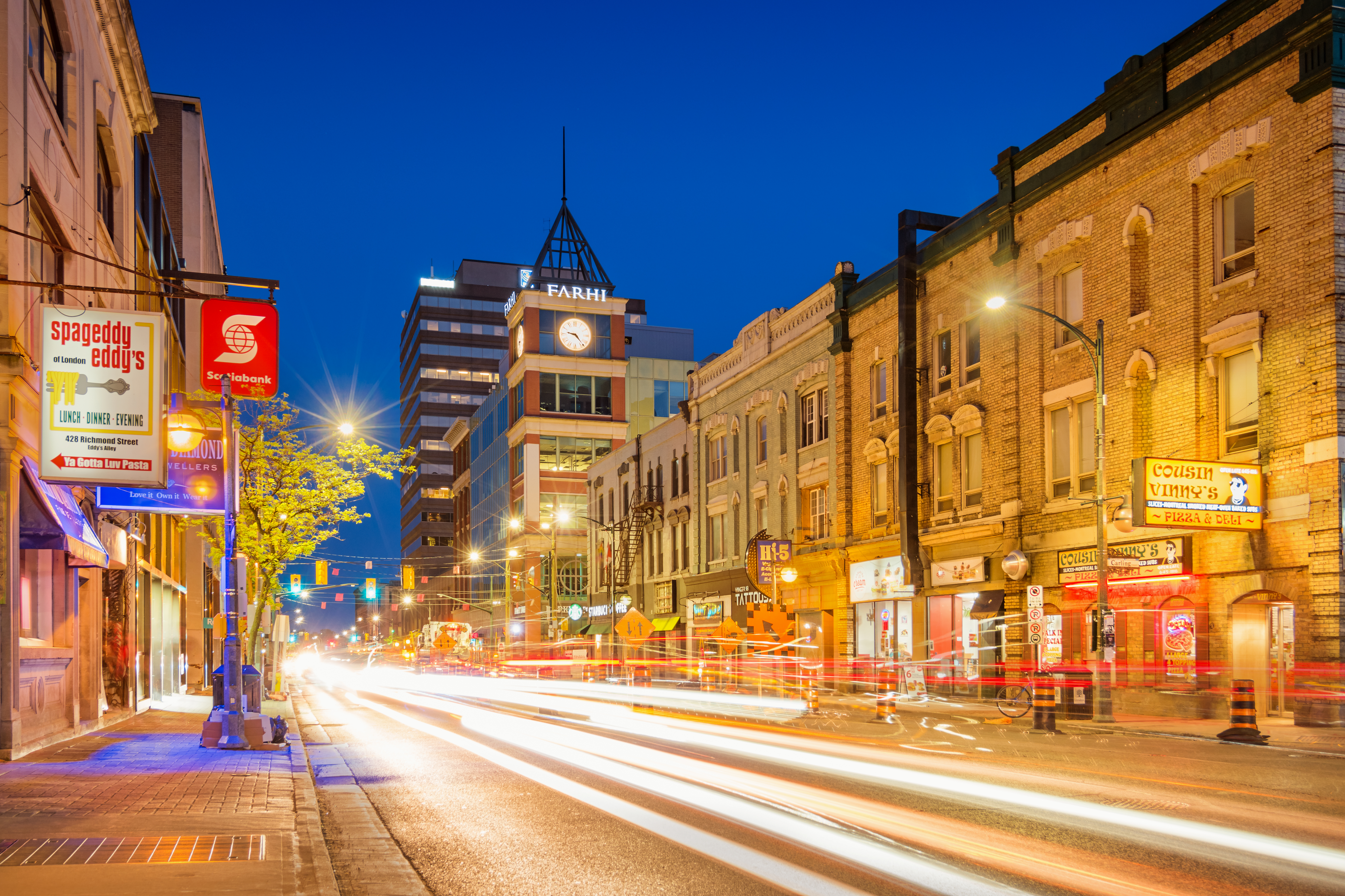 Cars driving on Richmond Street in downtown at twilight blue hour.