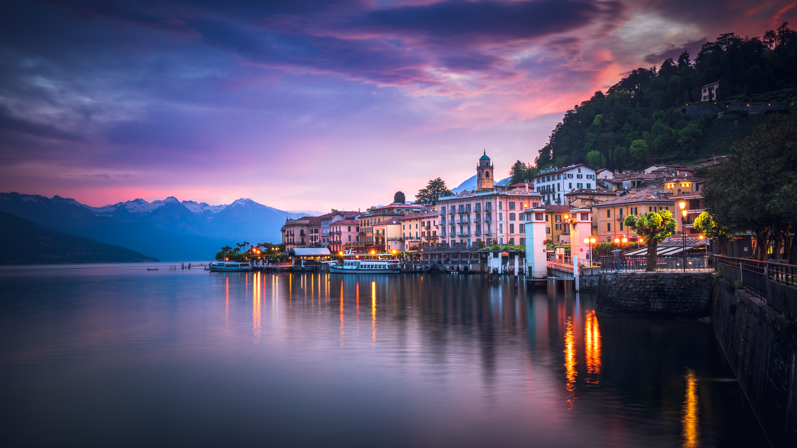 Sunrise over lake town with brilliant purple hues and waters