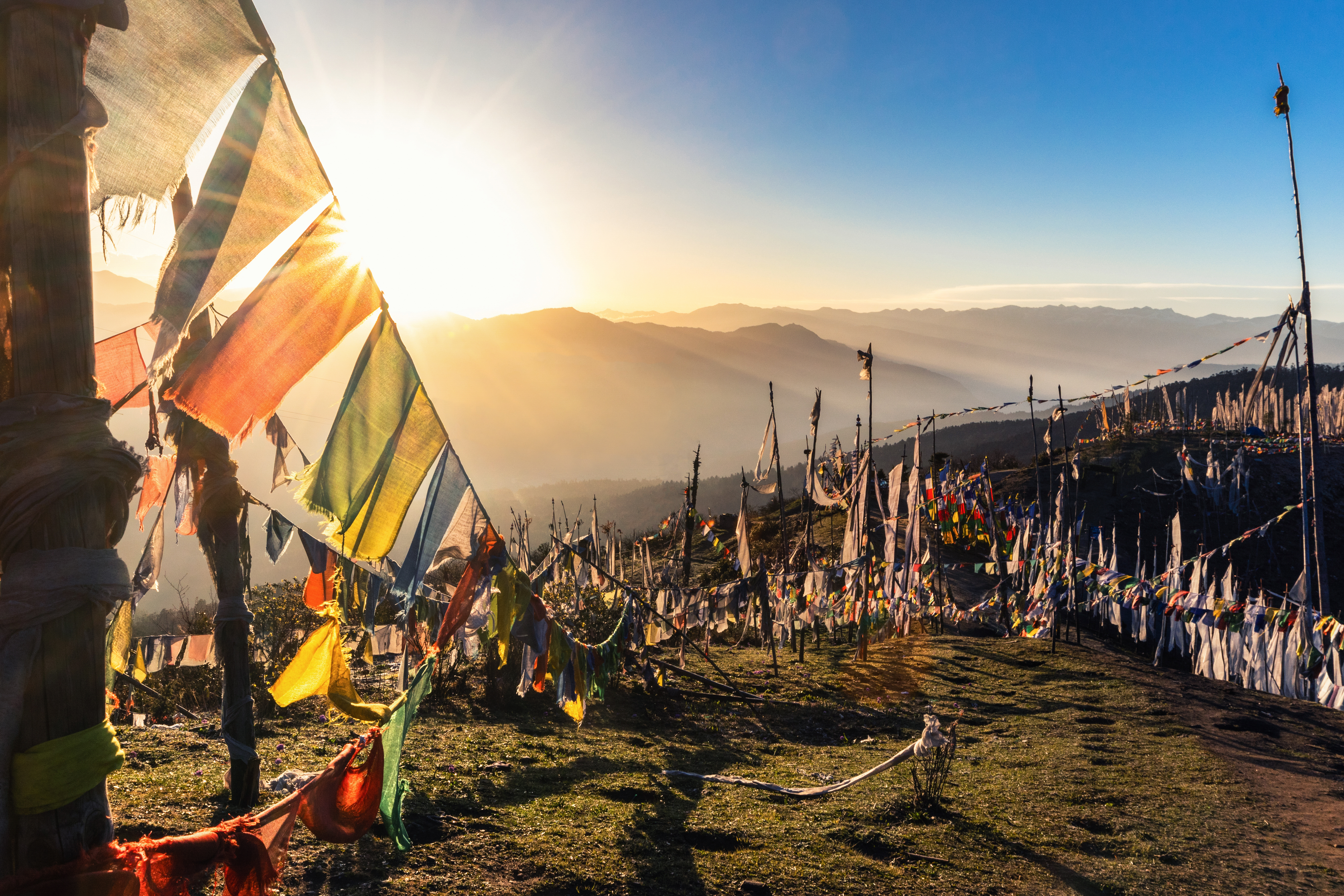 Sunrise at 4000 meters at the highest pass of Bhutan, Chele la with prayer flags flying in the wind