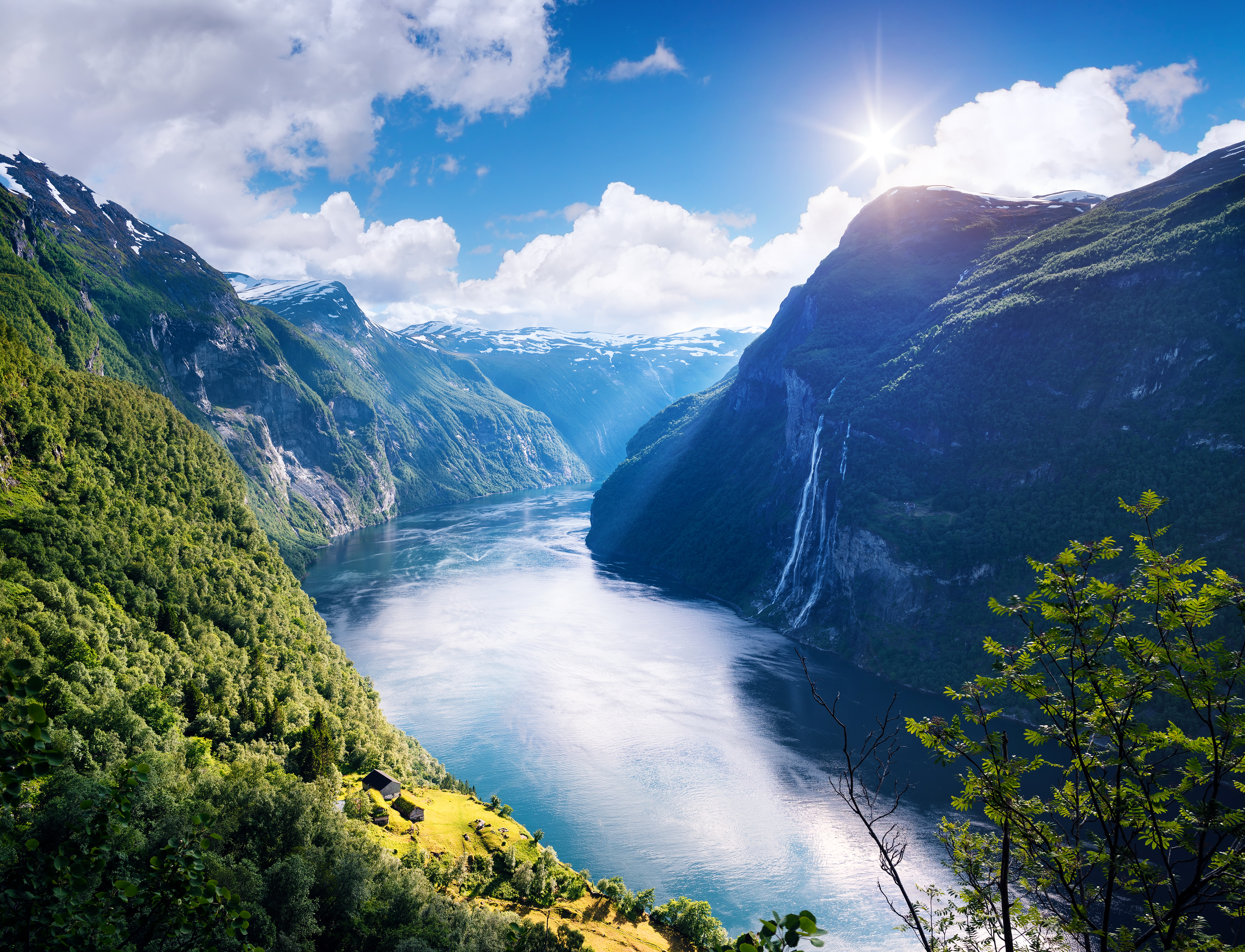 View of the old mountain farm and the famous waterfall overlooking the stunning fjord