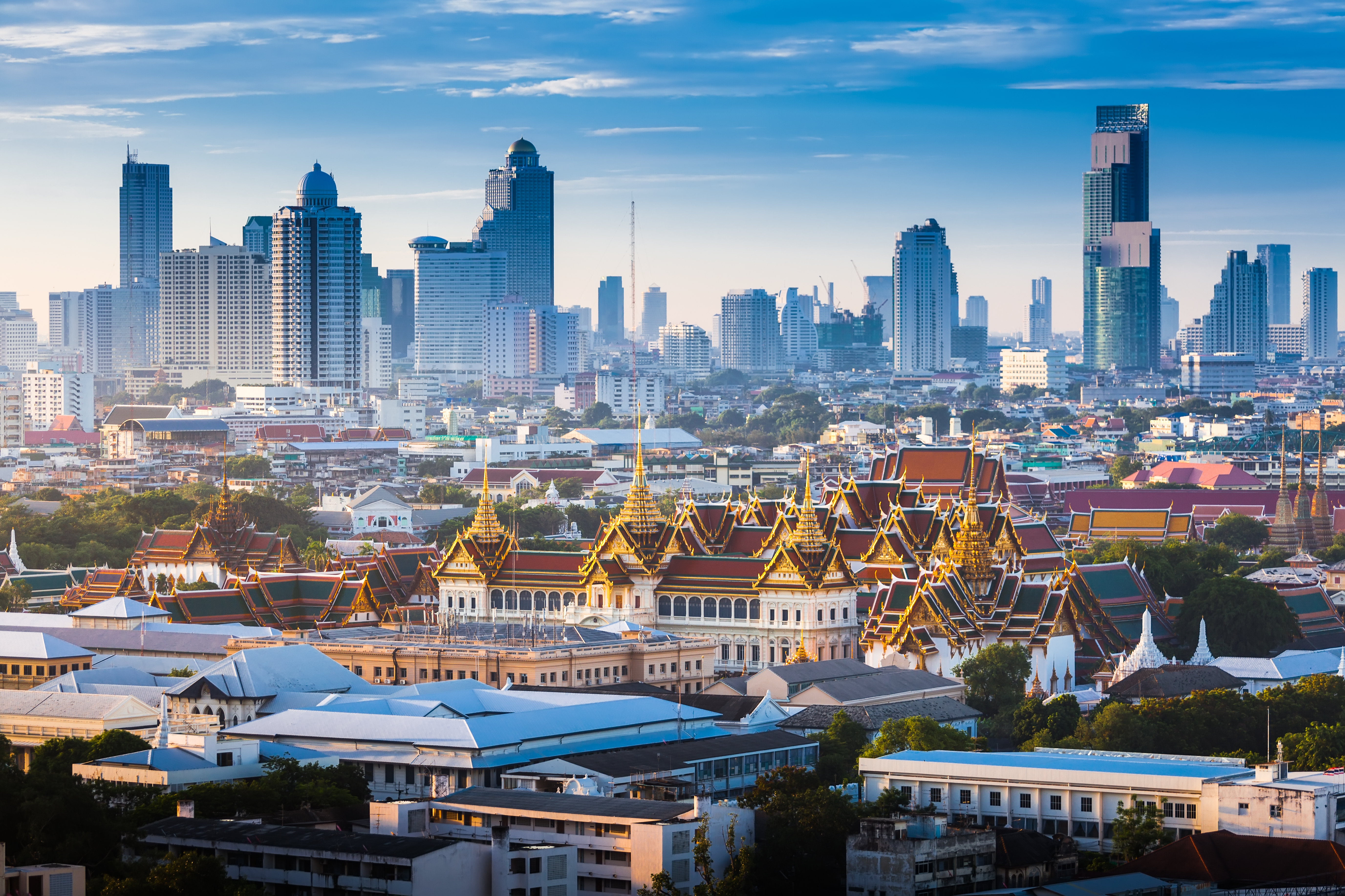 Sunrise of Bangkok tower skyline with The Grand Palace in foreground
