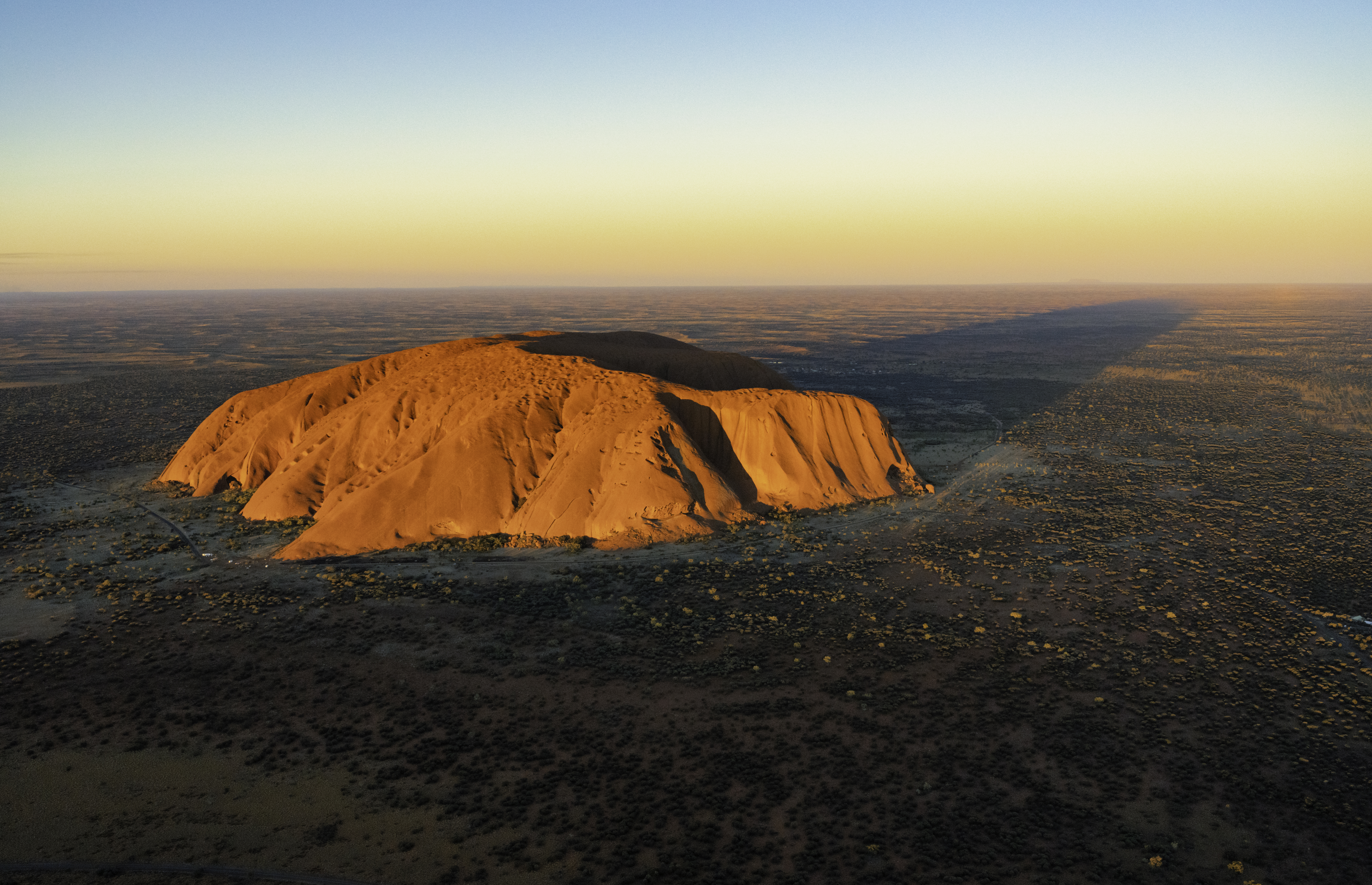 Evening sun shines down on the magnificence of Uluru