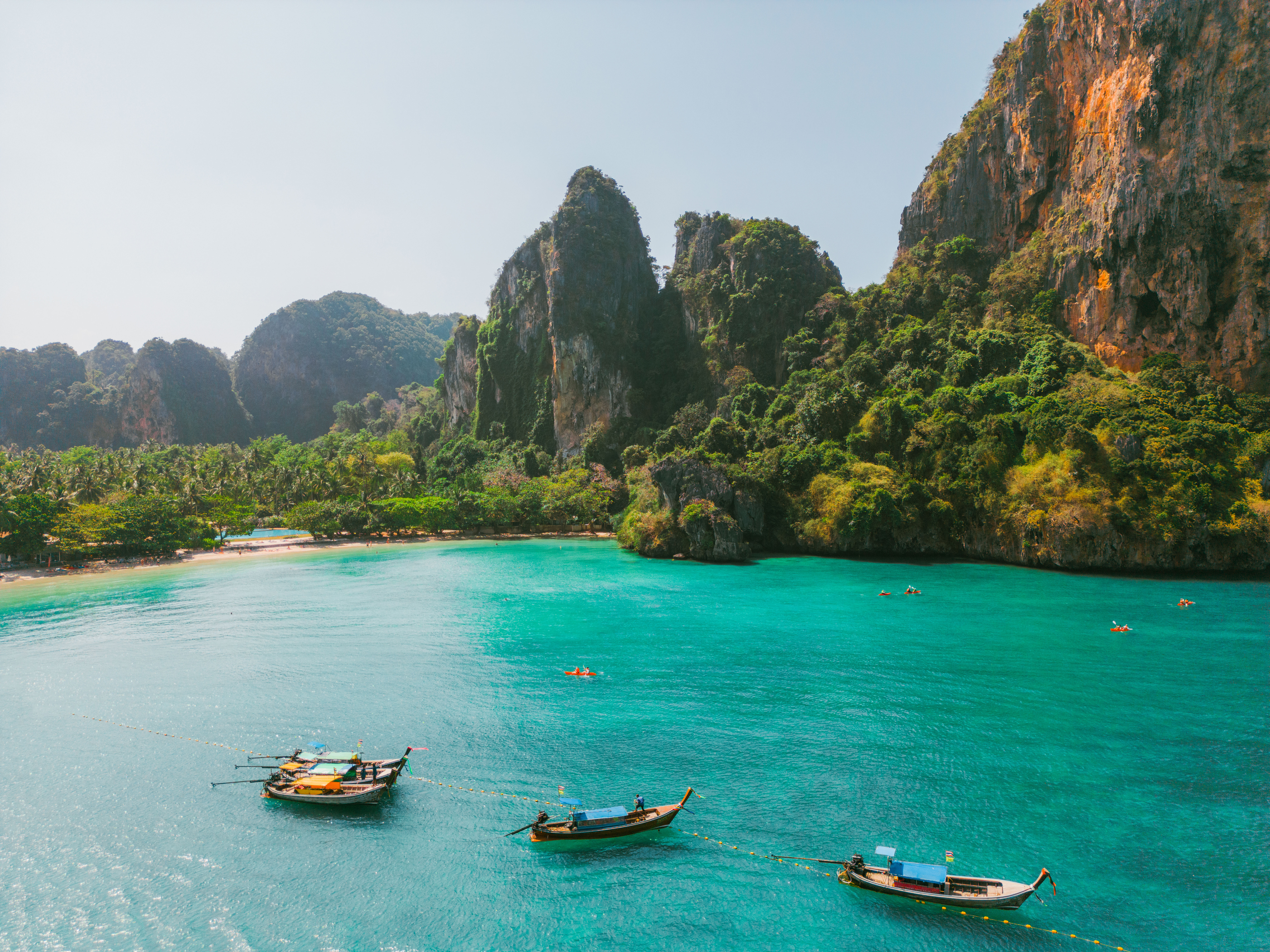 Scenic aerial view of sea kayaking near idyllic Railey beach in Thailand