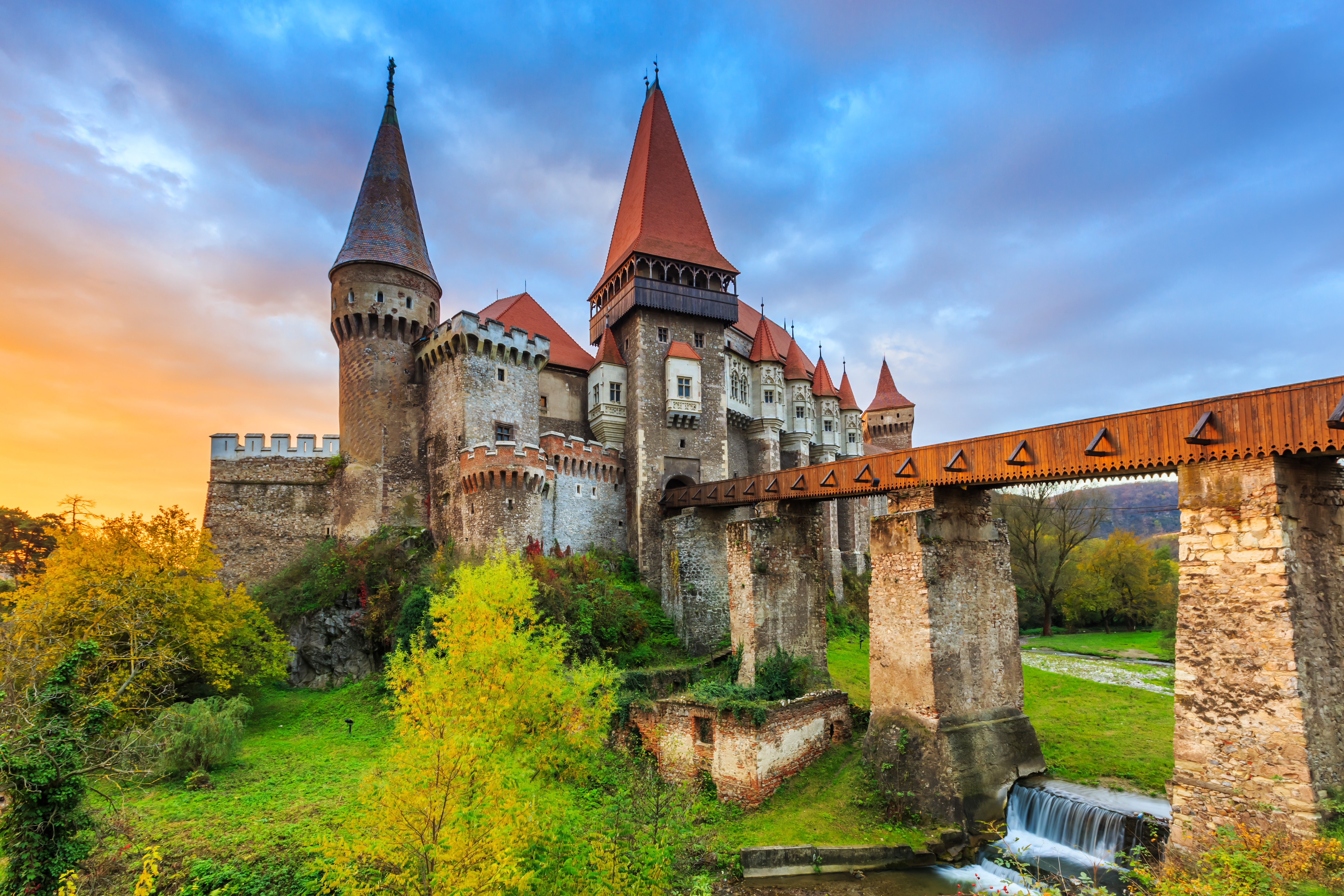 a medieval castle with a bridge over a river