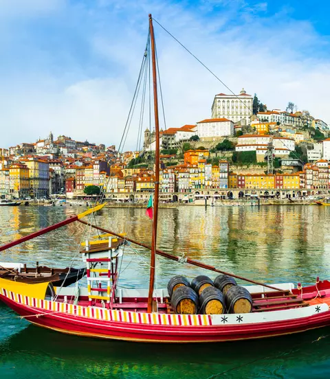 Panorama of beautiful Porto with traditional boats on the river
