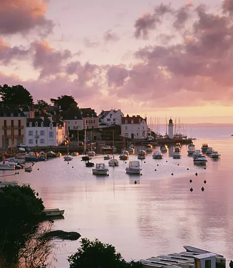 Harbour with boats in the water at sunset