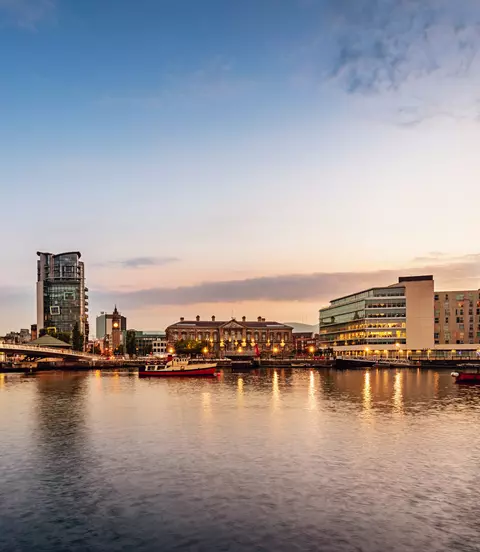 Panorama of Belfast River Lagan Waterfront Cityscape and Lagan Bridge at Sunset Twilight