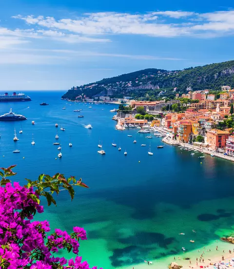 Aerial view of the vibrant town and beach with boats in the water