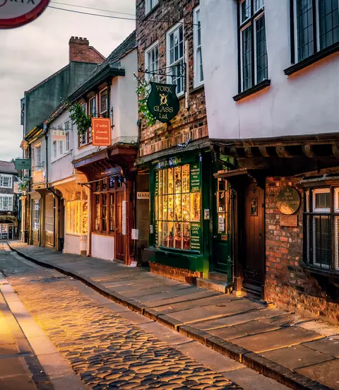 The Shambles, a medieval street preserved in the heart of the English city of York, still busy with boutique shops and cafes