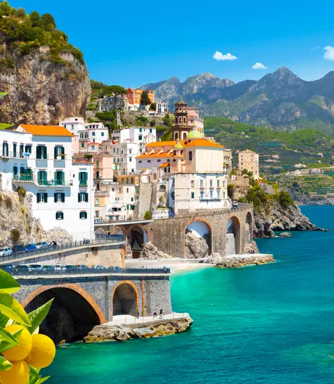 Beautiful view of Amalfi on the Mediterranean coast with lemons in the foreground