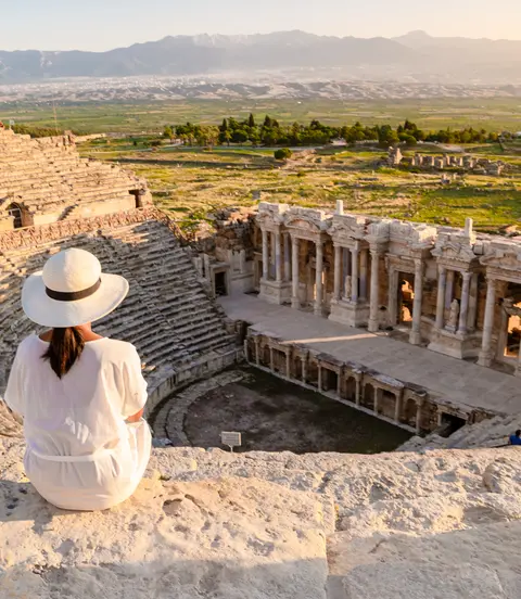 Hierapolis ancient city Pamukkale Turkiye, a young watching the sunset by the ruins Unesco site