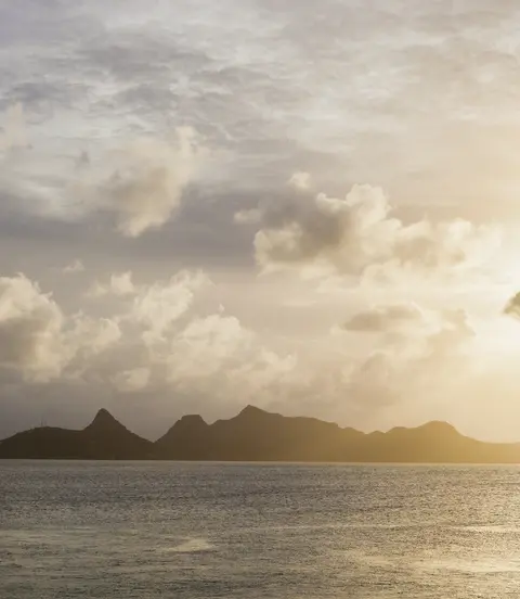 Cruise ship moored off Mayreau Island, one of the Grenadines. The island in the background is Union Island.