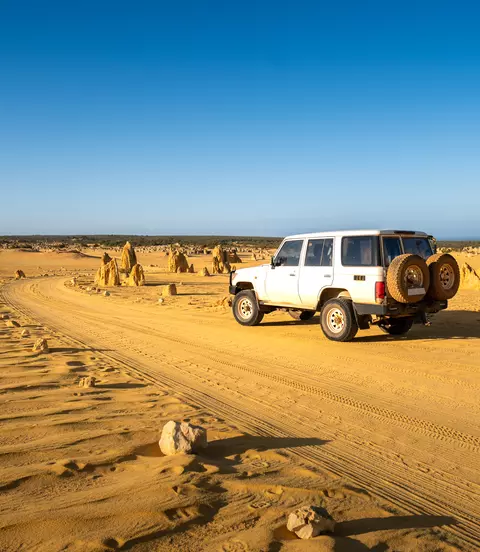 Four-wheel-drive car in the Pinnacles Desert, Nambung National Park, Western Australia.