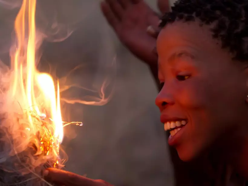 A women making fire as seen while travelling on your Serengeti National Park safari.