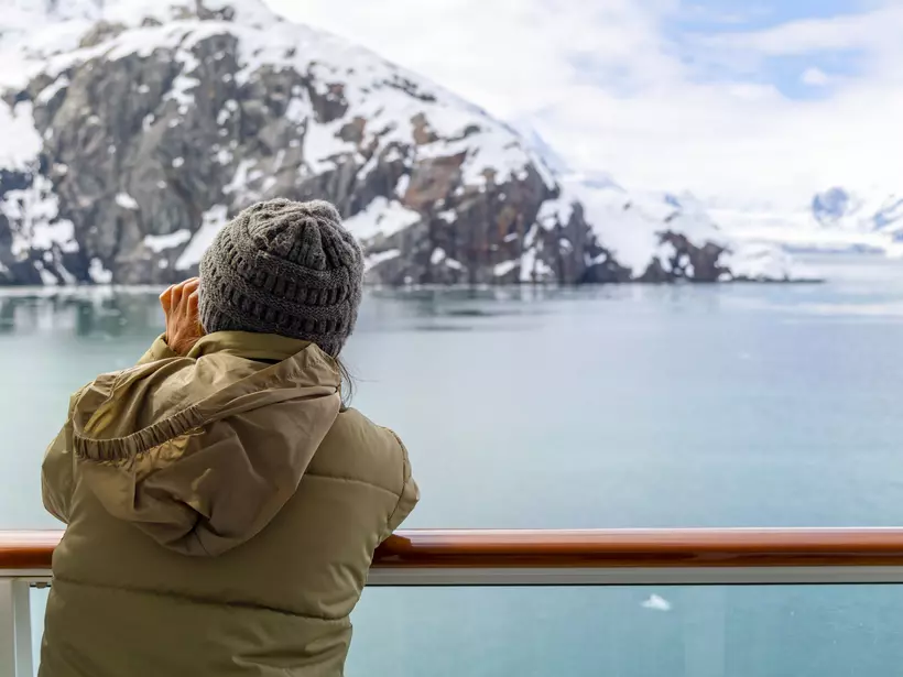 A tourist takes an icy picture from a cruise ship