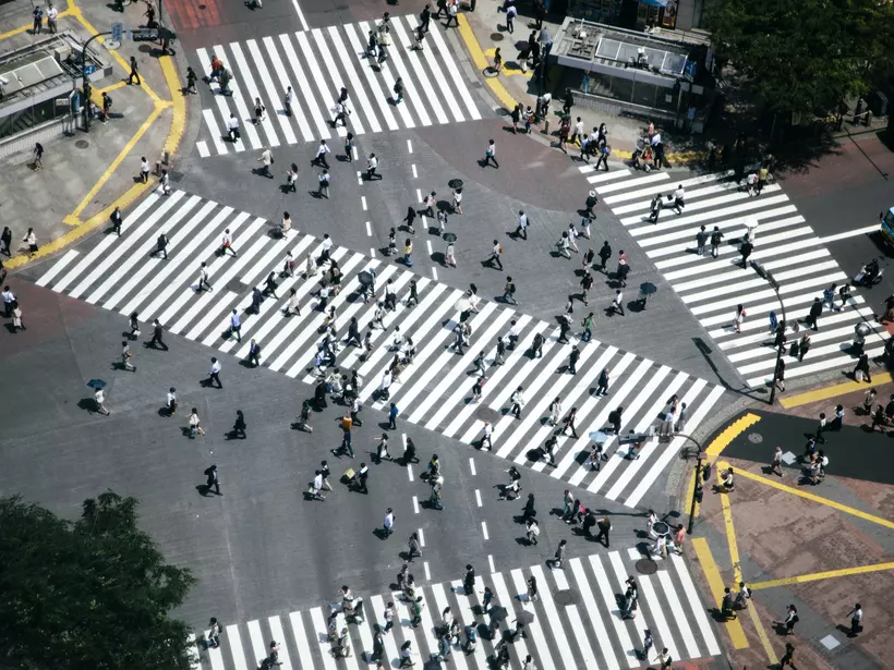 Shibuya crossing, pedestrians crossing the road, aerial view. Spring, daylight
