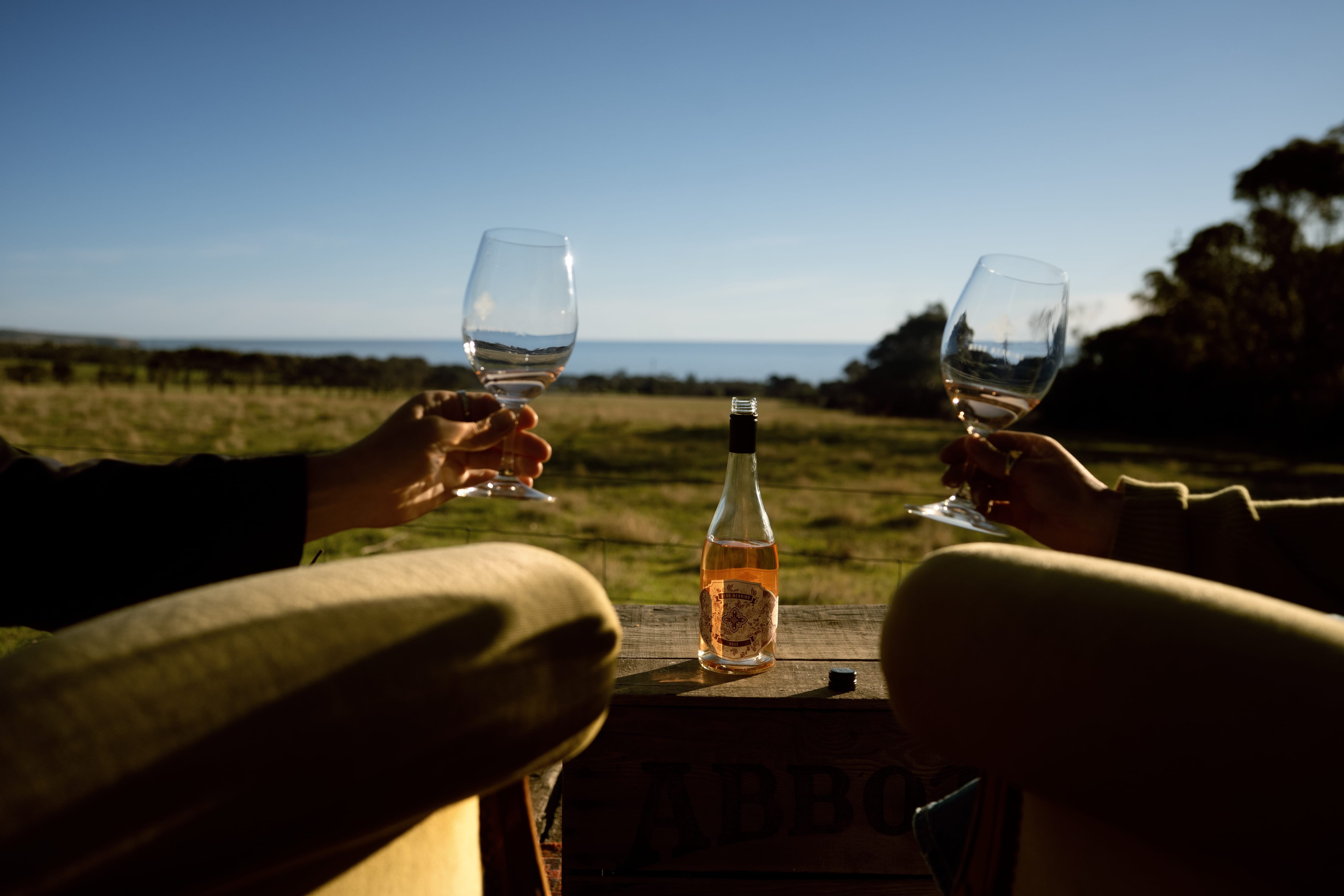 A close up of two glasses during a cheers at the Berg Herring Wines on the Fleurieu Peninsula in South Australia.