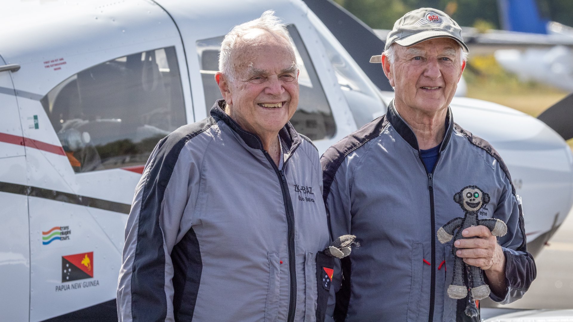 Papua New Guinea Bob Bates and Barry “Baz” Payne in front of their single-engine monoplane.