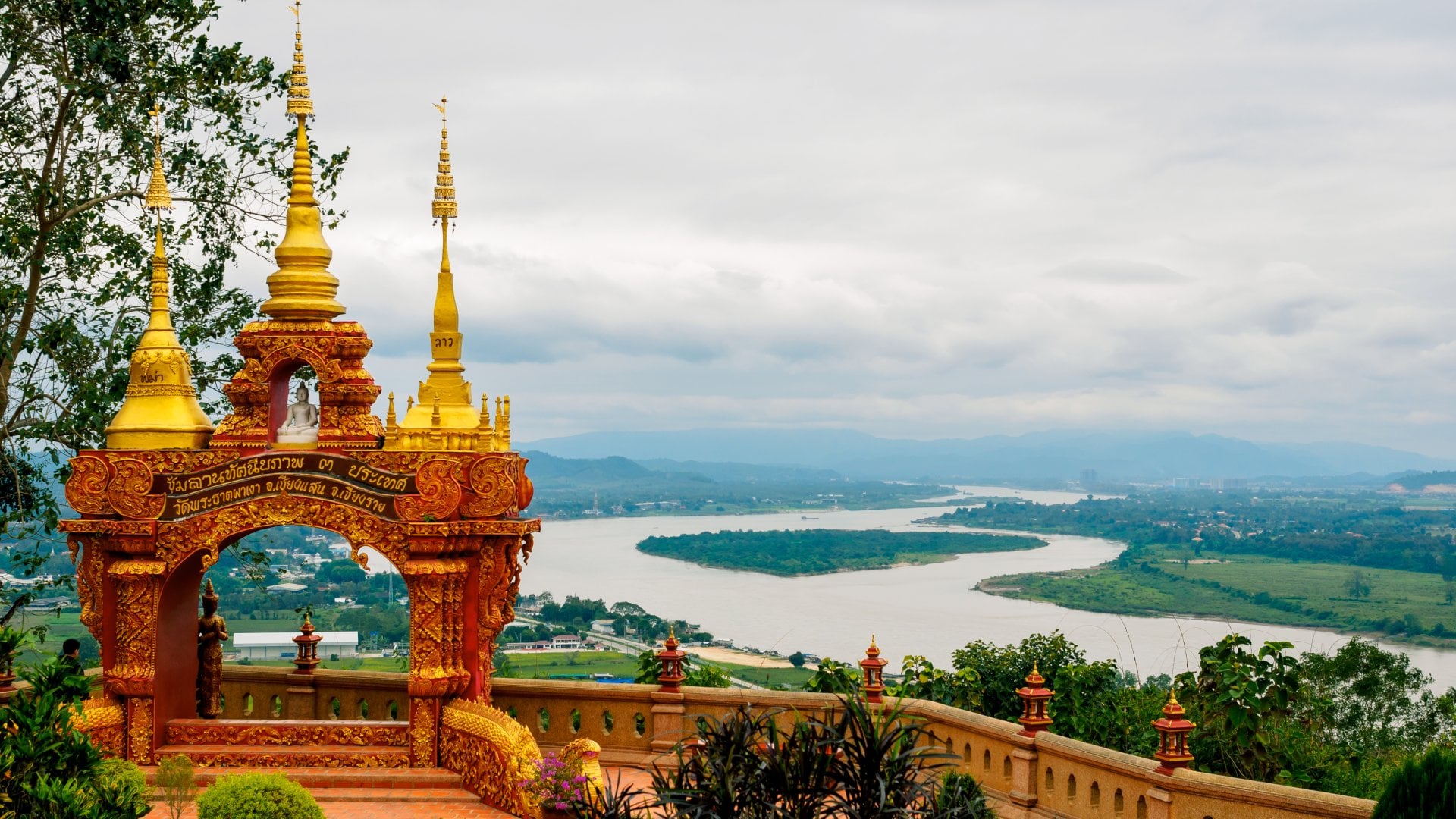 Arch with 3 golden pagodas representing Thailand, Myanmar, Laos at Pra Thad Pha Ngo Temple, Chang Saen, Thailand Vacations