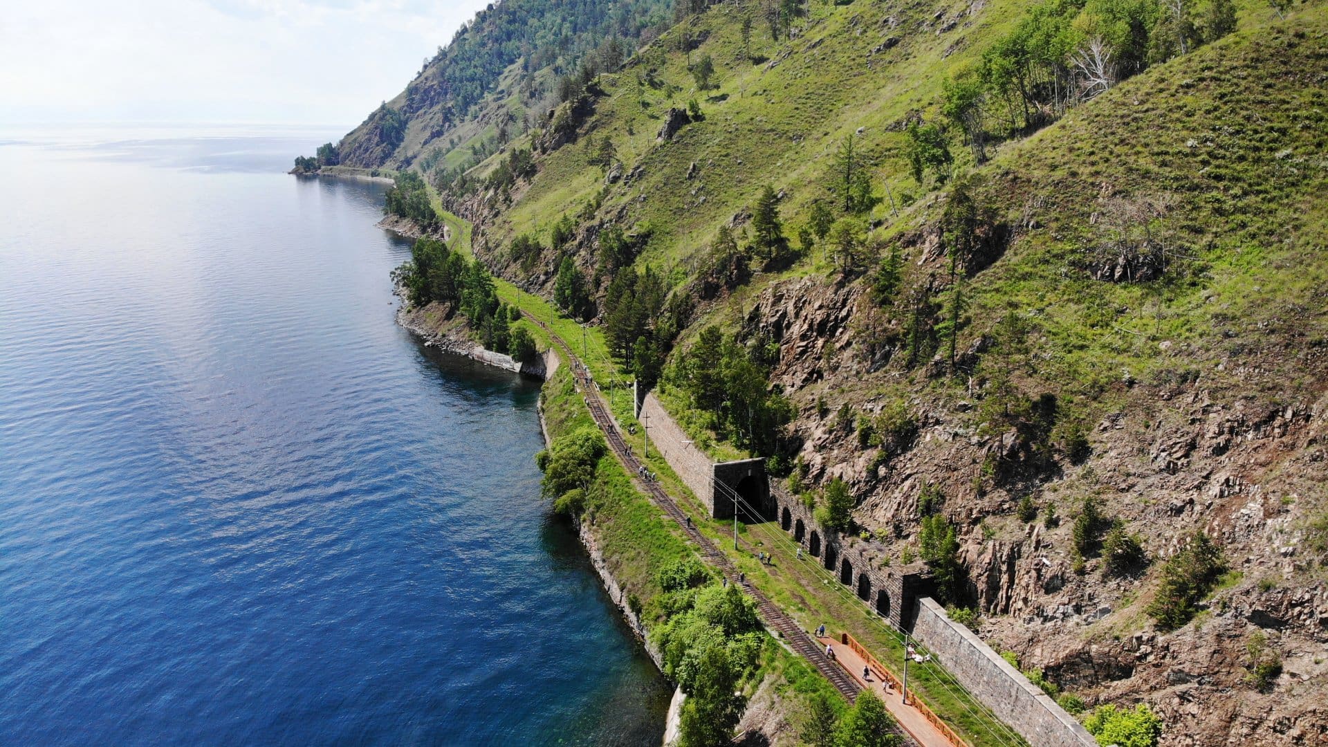 Baikal lake. Old stone arch tunnel and stone wall in mountain the rock on the Circum-Baikal railway in summer