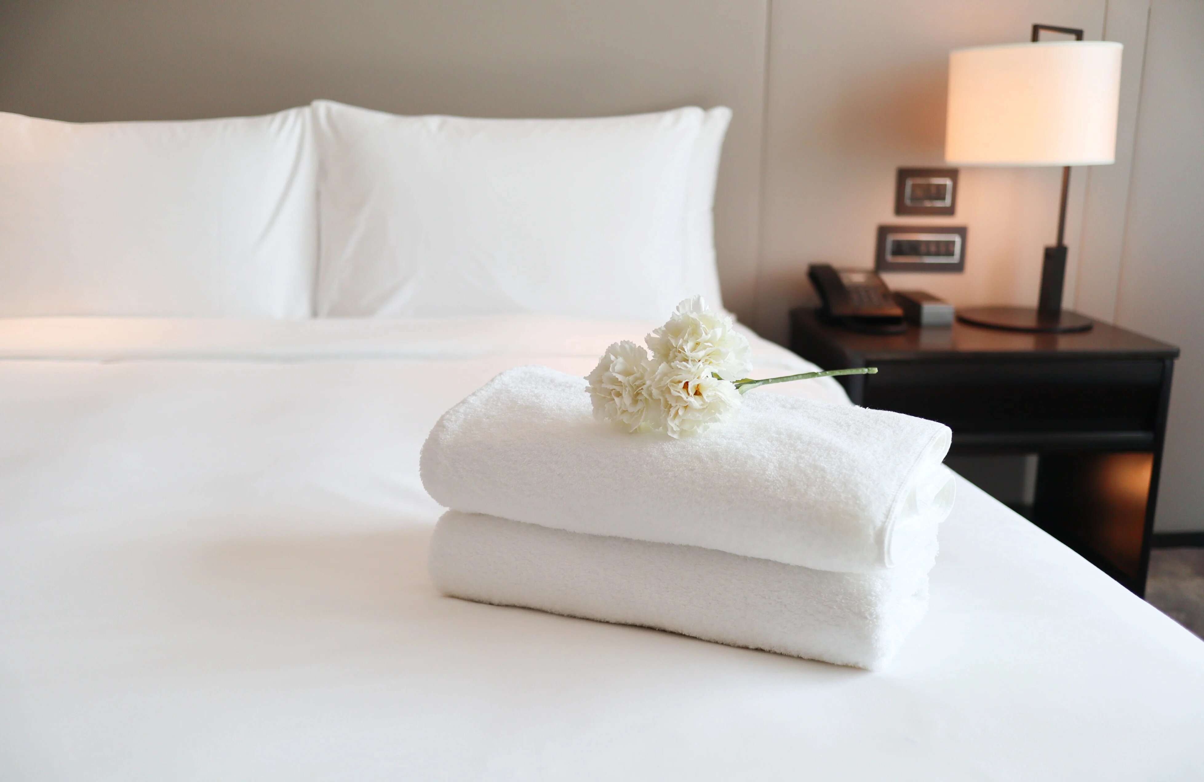 Clean white bath towels on the neatly clean bedroom - coziness and clean