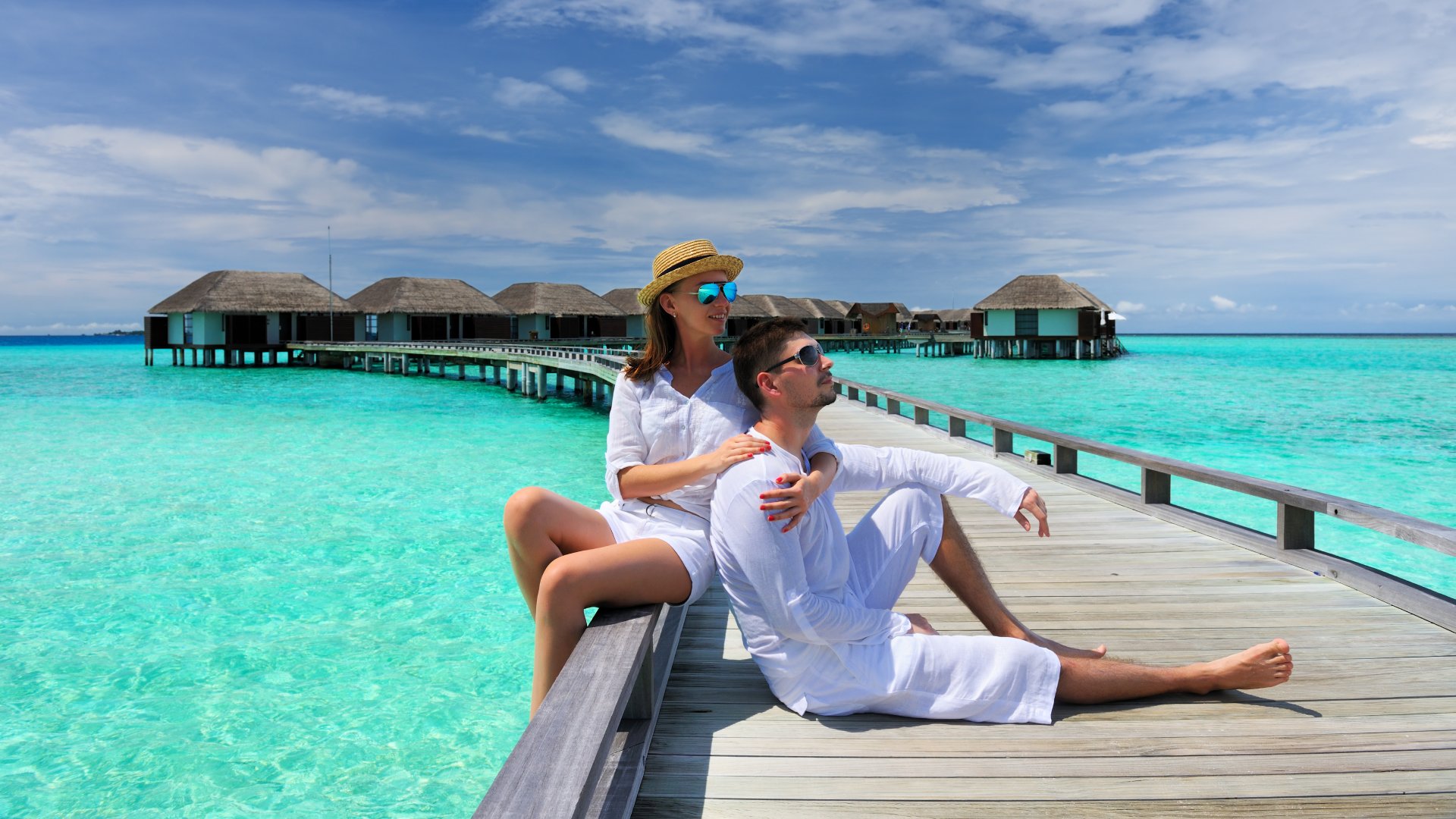 Couple on a Tropical Beach Jetty, Maldives