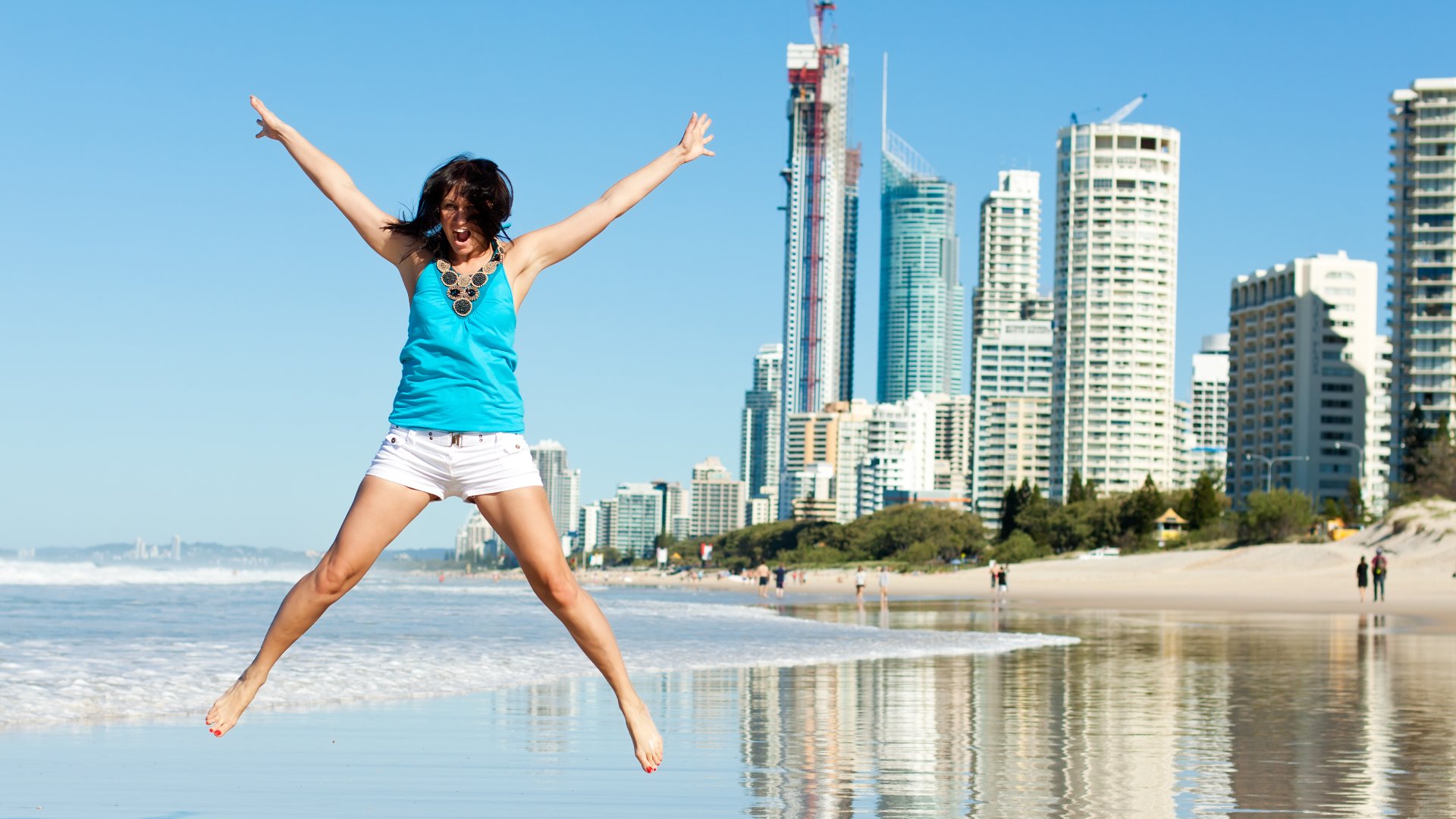 Happy Woman Jumping for Joy on Beach Along the Gold Coast, Queensland, Australia