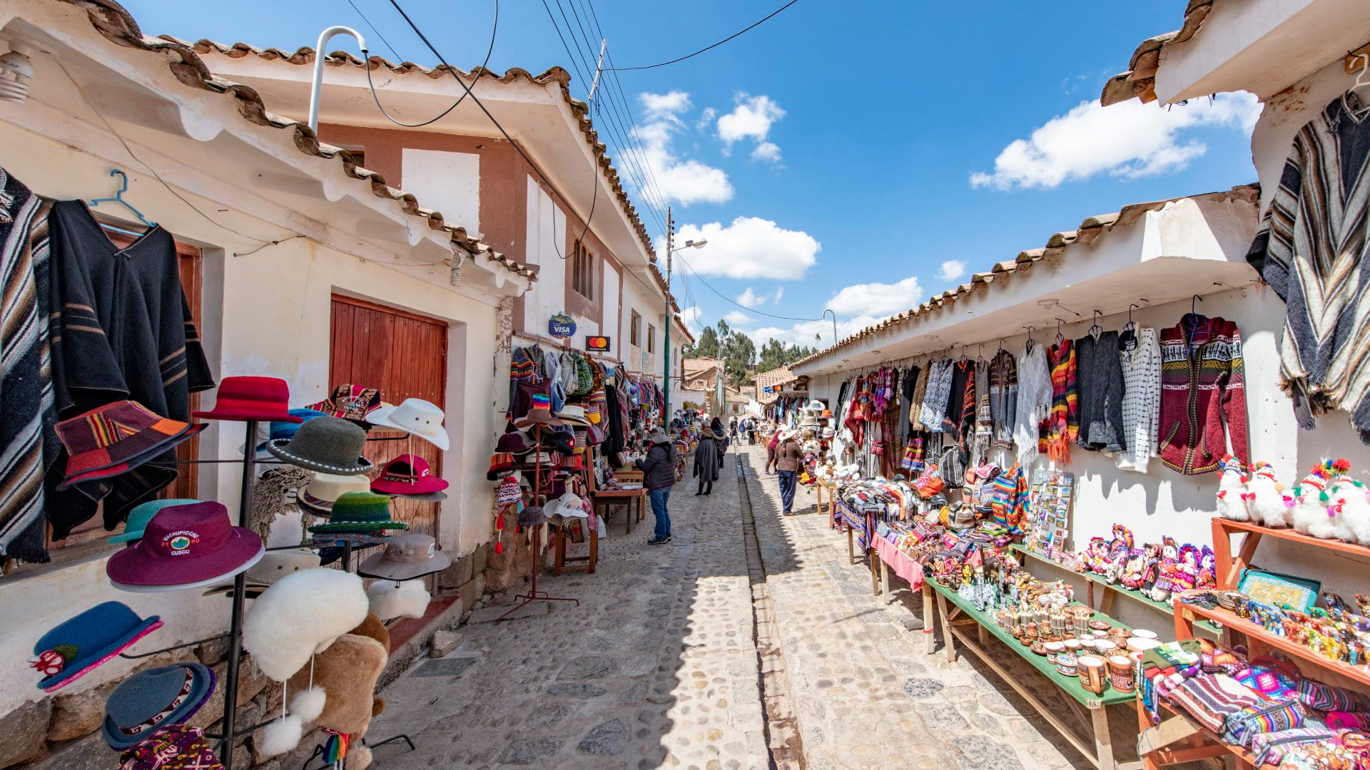 Locals selling souvenirs on a street in the village of Chinchero. The village is located at 3700 m above sea level, surrounded by the Andean mountains, at the Sacred Valley in Peru.